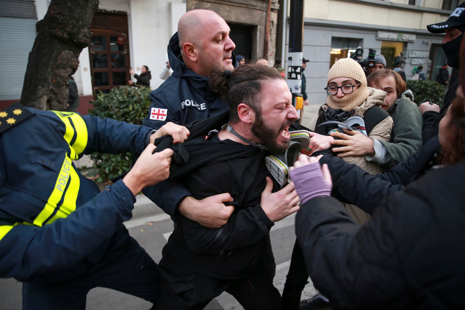 FILE - Police try to detain a protester during a rally against the results of the parliamentary elections amid allegations that the vote was rigged in Tbilisi, Georgia, on Nov. 19, 2024. (AP Photo/Zurab Tsertsvadze, File)