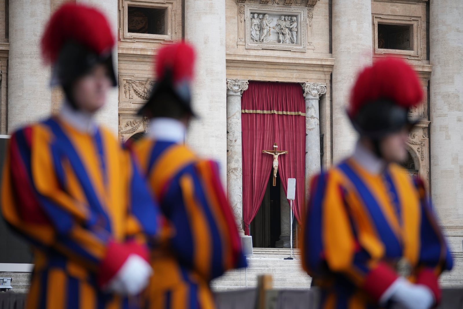 Vatican Swiss Guards frame the entrance of St. Peter's Basilica where the body of Pope Francis will lie in state for three days, at the Vatican, Wednesday, April 23, 2025. (AP Photo/Andrew Medichini)