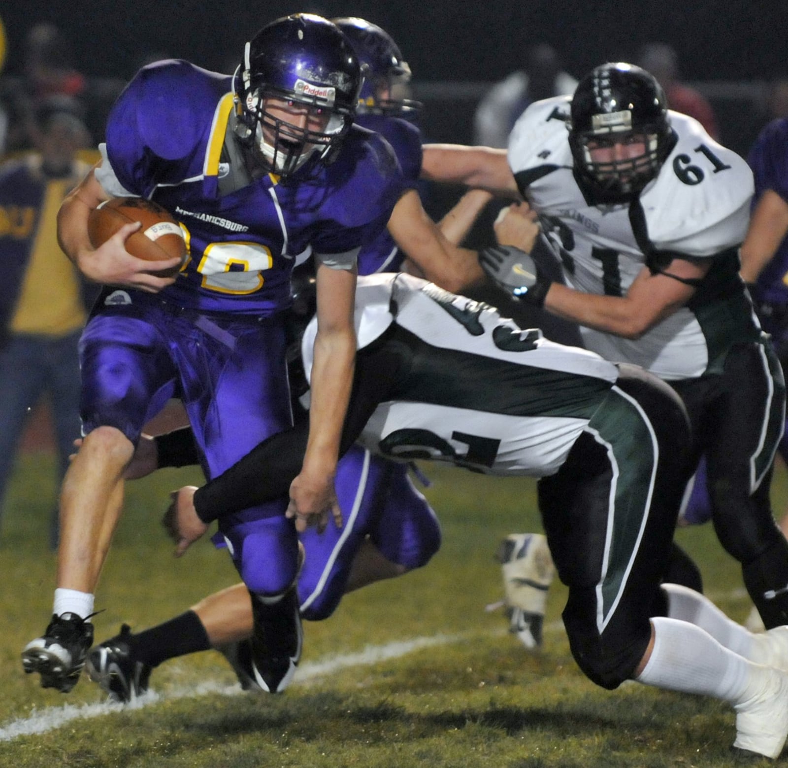 Mechanicsburg’s David Bethel is tackled around the legs by New Miami’s Kris Roberts during a 2008 Division VI, Region 24 playoff game at Mechanicsburg. The host Indians won 42-0. BILL LACKEY/STAFF