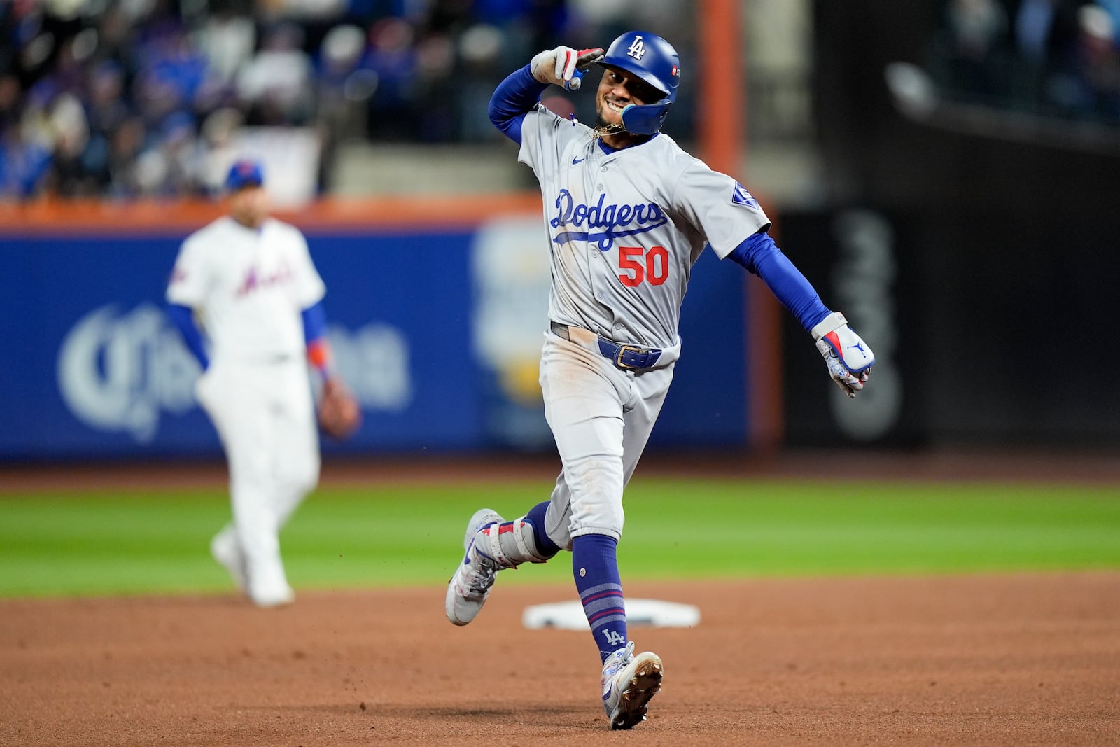 Los Angeles Dodgers' Mookie Betts celebrates after a two-run home run against the New York Mets during the sixth inning in Game 4 of a baseball NL Championship Series, Thursday, Oct. 17, 2024, in New York. (AP Photo/Frank Franklin II)