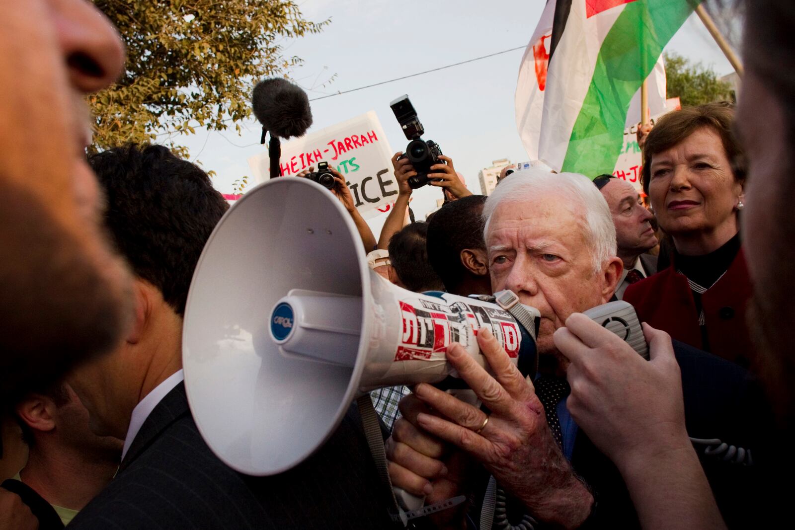 FILE - Former president of Ireland Mary Robinson, background right, looks at former U.S. President Jimmy Carter, center, while visiting a weekly protest in the east Jerusalem neighborhood of Sheikh Jarrah, on Oct. 22, 2010. The protest was organized by groups supporting Palestinians evicted from their homes in east Jerusalem by Israeli authorities. (AP Photo/Bernat Armangue, File)