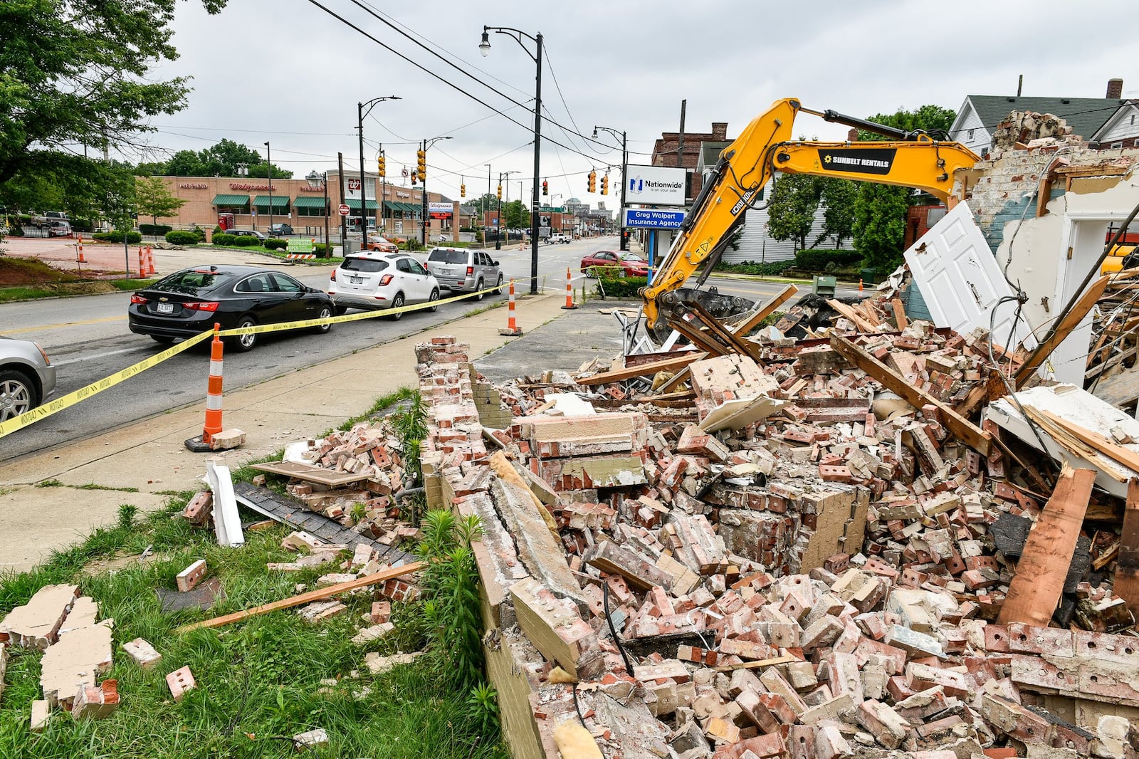 The former Wolpert insurance agency is among buildings that are being demolished to make way for soon-to-come improvements to the crossroads of Main Street with Eaton and Millville Avenues. Businesses remain open during construction on Main Street in Hamilton. NICK GRAHAM/STAFF