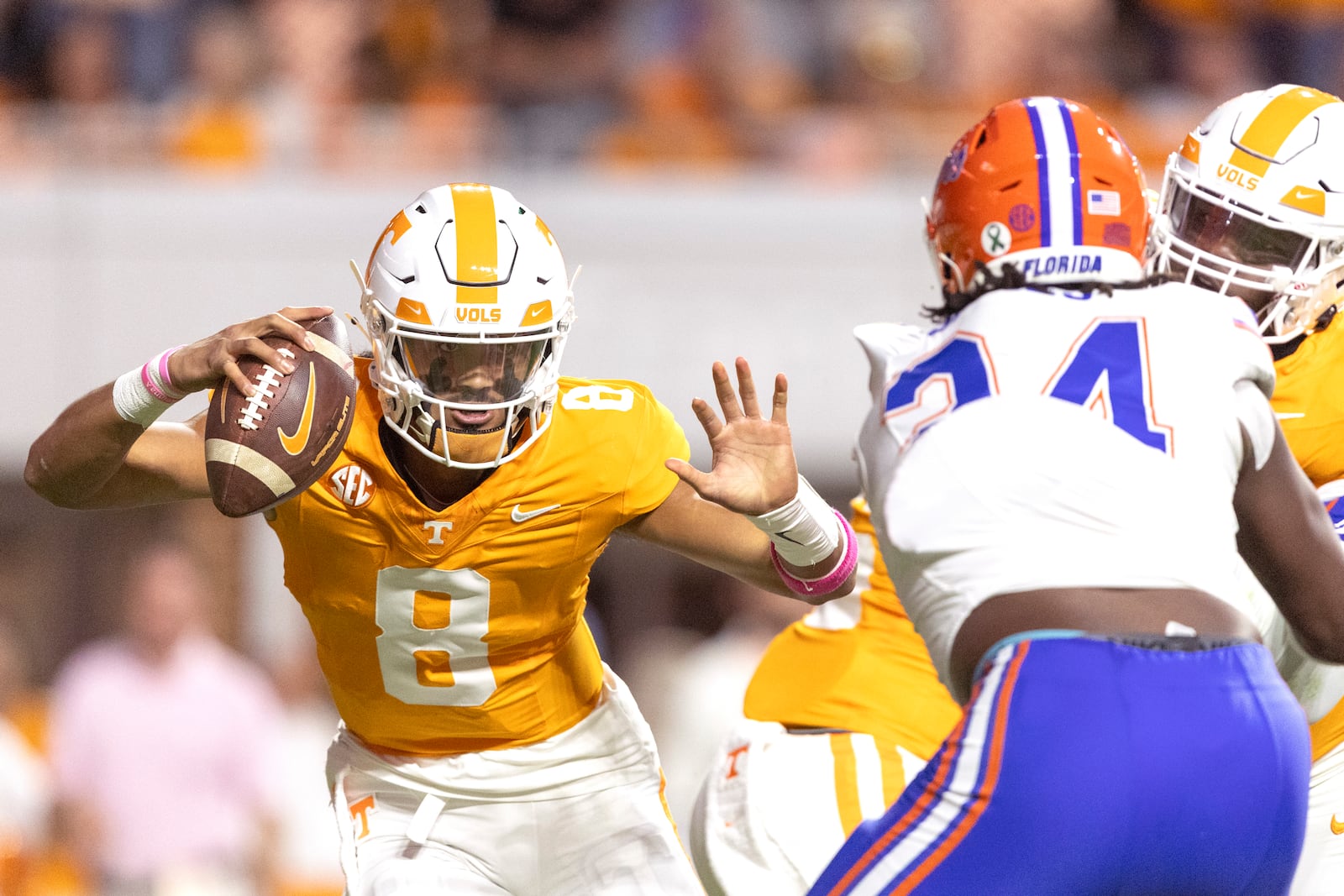 Tennessee quarterback Nico Iamaleava (8) tries to escape the grasp of Florida edge Kamran James (24) during the first half of an NCAA college football game, Saturday, Oct. 12, 2024, in Knoxville, Tenn. (AP Photo/Wade Payne)