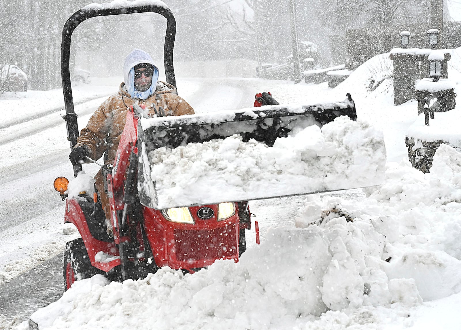 Matt Hodges plows snow from his driveway in Beckley, W.Va., Tuesday, Feb. 11, 2025. (Rick Barbero/The Register-Herald via AP)