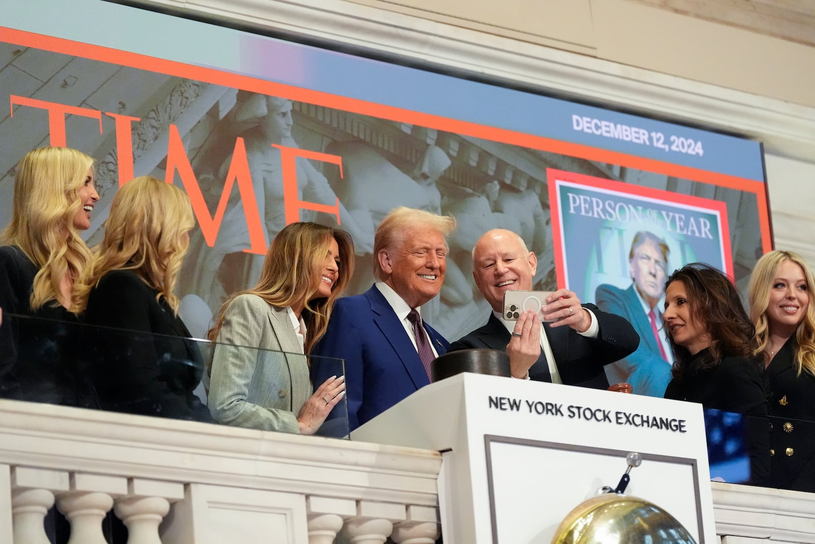 President-elect Donald Trump stands for a selfie after ringing the opening bell at the New York Stock Exchange, Thursday, Dec. 12, 2024, in New York. (AP Photo/Alex Brandon)