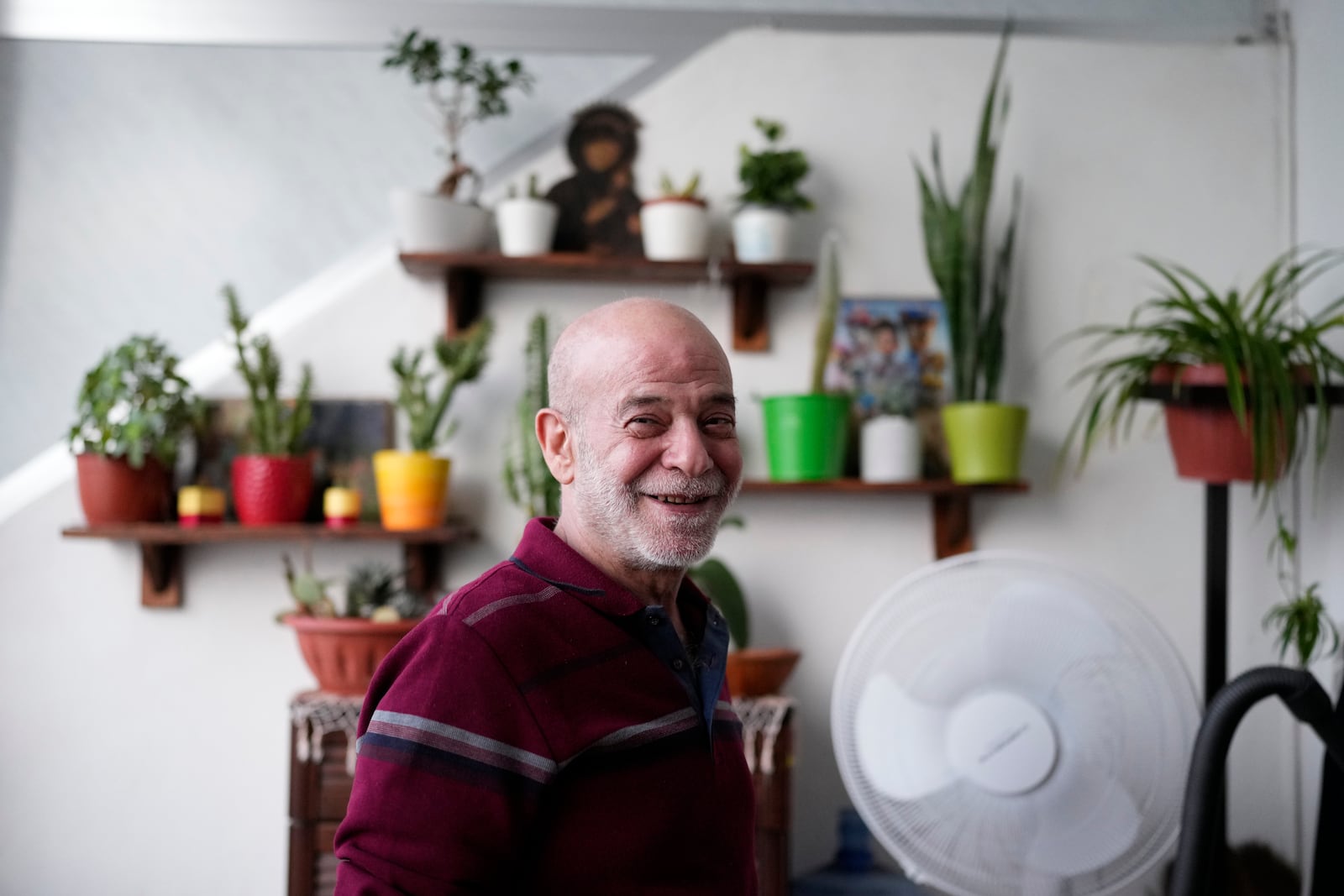 Suheil Hamwi, who spent 32 years in prison in Syria and returned to Lebanon after the government of Bashar Assad was toppled, poses for a photograph inside of his home in Chekka, Lebanon, Tuesday, Dec. 10, 2024. (AP Photo/Hassan Ammar)