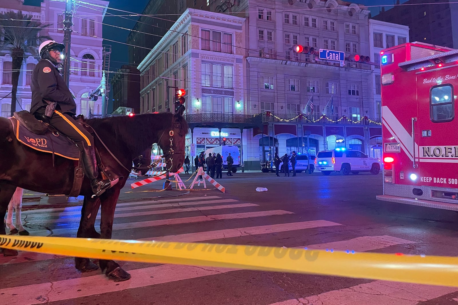 A mounted police officer arrives on Canal Street after a vehicle drove into a crowd earlier in New Orleans, Wednesday Jan. 1, 2025. (AP Photo/Kevin McGill)