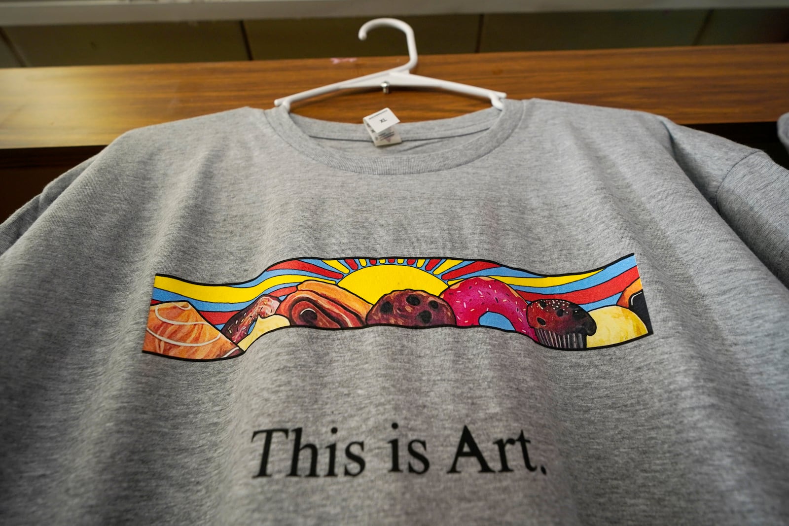 FILE -- A T-shirt showing the painting displayed outside Leavitt's Country Bakery, is displayed in the store in this April 13, 2023 file photo, in Conway, N.H. (AP Photo/Robert F. Bukaty, file)