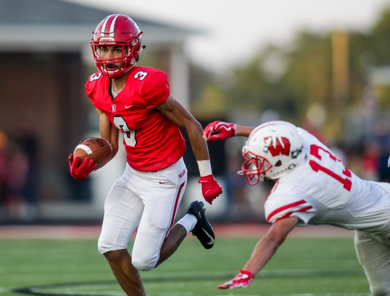 Fairfield’s Peyton Brown gets past Lakota West’s Mason Truman during last Friday’s game at Fairfield Stadium. Brown’s Indians won 37-3. NICK GRAHAM/STAFF