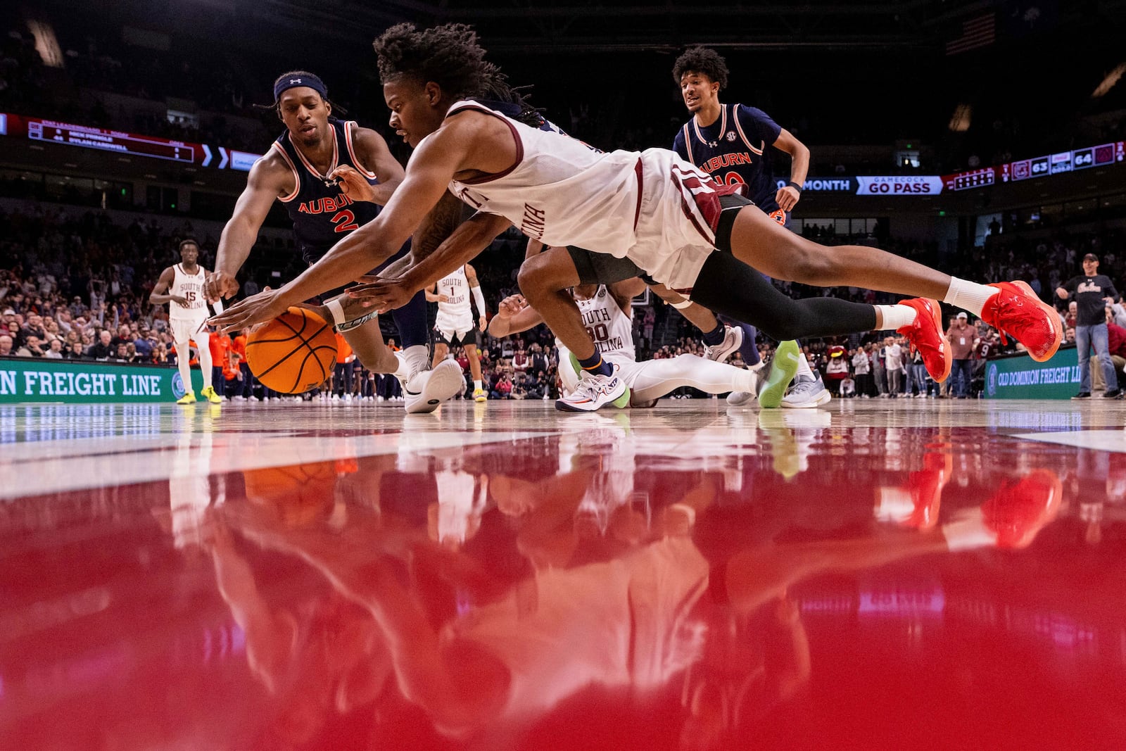 South Carolina forward Nick Pringle (5) and Auburn guard Denver Jones (2) dive for a loose ball during the second half of an NCAA college basketball game on Saturday, Jan. 11, 2025, in Columbia, S.C. (AP Photo/Scott Kinser)