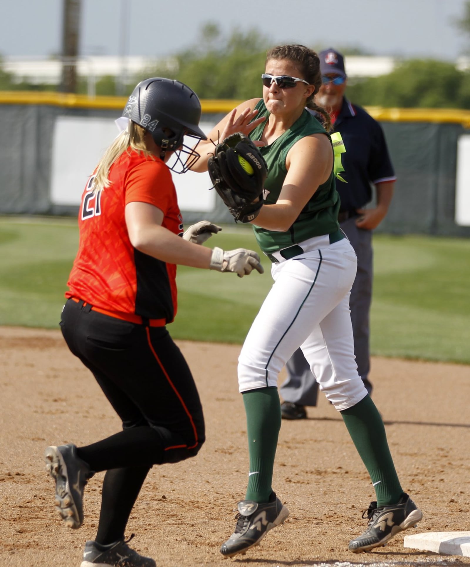 Badin’s Danielle Ray tags out Richwood North Union’s Maddison Ruhl at first base during a Division III regional semifinal at Wright State University on May 27, 2015. LISA POWELL/STAFF