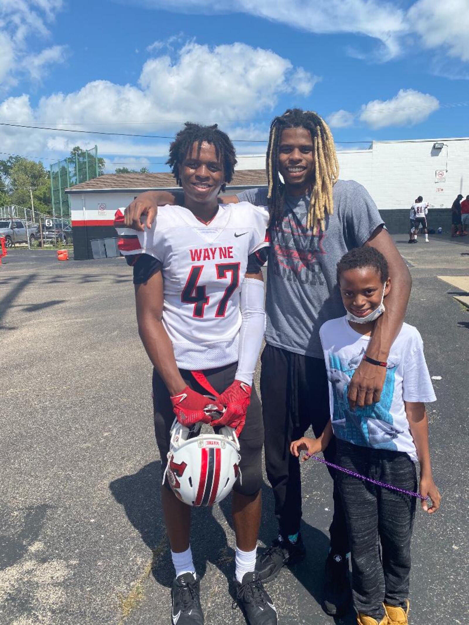 Ja'don Rucker-Furlow with brother Romeo (No. 47) who plays at Wayne and 10-year-olf brother London. CONTRIBUTED