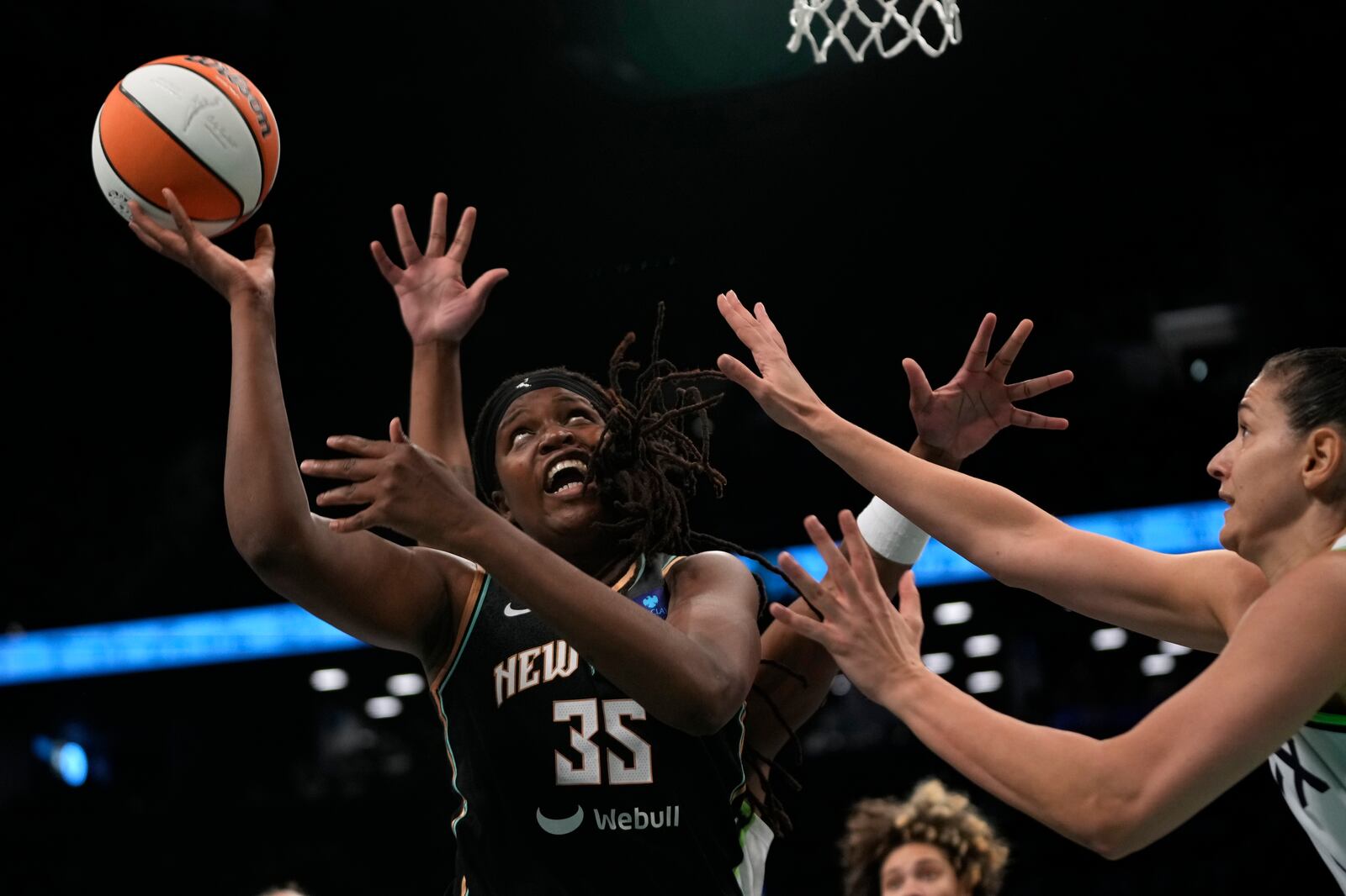 New York Liberty's Jonquel Jones, left, attempts to score during the first half in Game 2 of a WNBA basketball final playoff series against the Minnesota Lynx, Sunday, Oct. 13, 2024, in New York. (AP Photo/Pamela Smith)