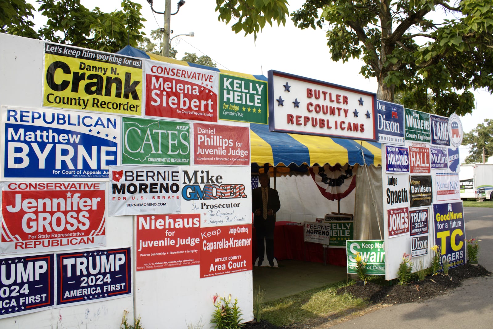 Simranjit Malhi volunteers at the Butler County Republicans tent at the Butler County Fair where people stop to take photos with a cutout of Donald Trump.