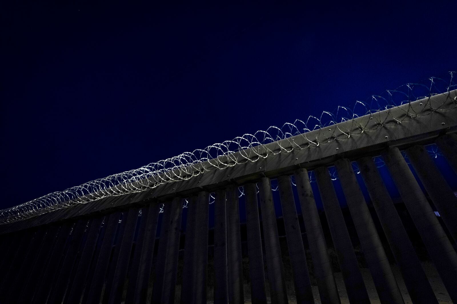 Concertina wire tops a section of a border wall separating Mexico from the United States Tuesday, Jan. 21, 2025, in San Diego. (AP Photo/Gregory Bull)