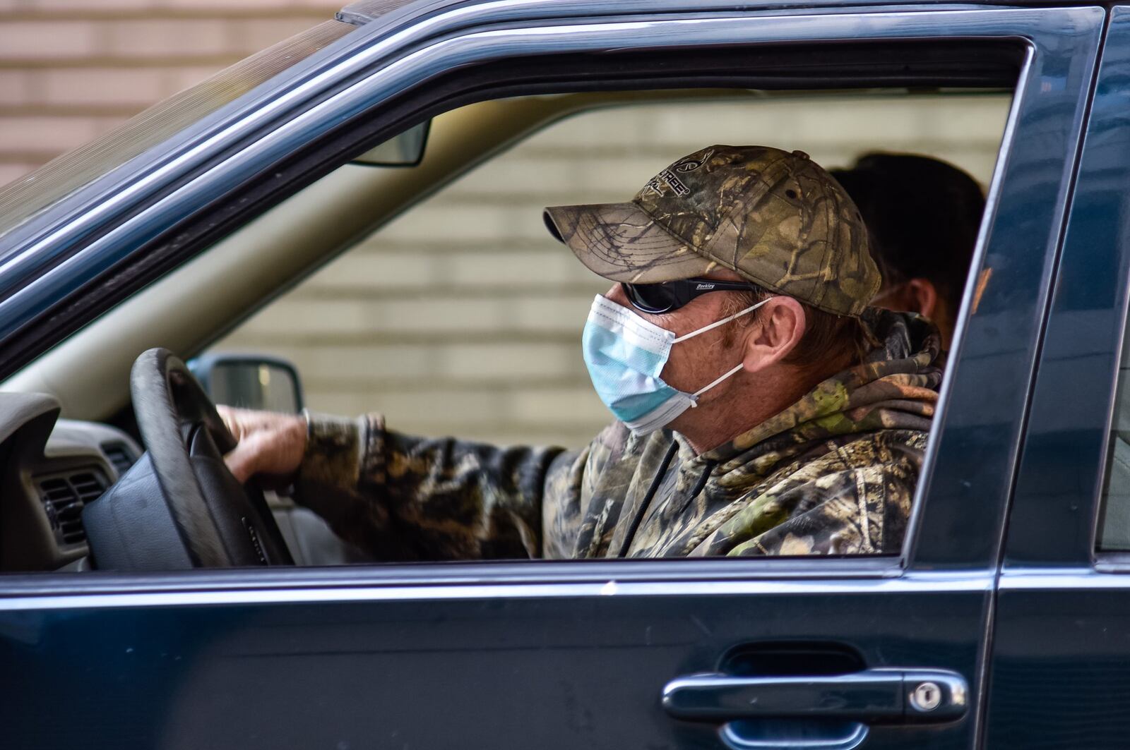 Bryan Lehman wears a mask in his car in downtown Hamilton Friday, April 3. Lehman is trying to wear a mask in public due to the coronavirus pandemic. NICK GRAHAM/STAFF