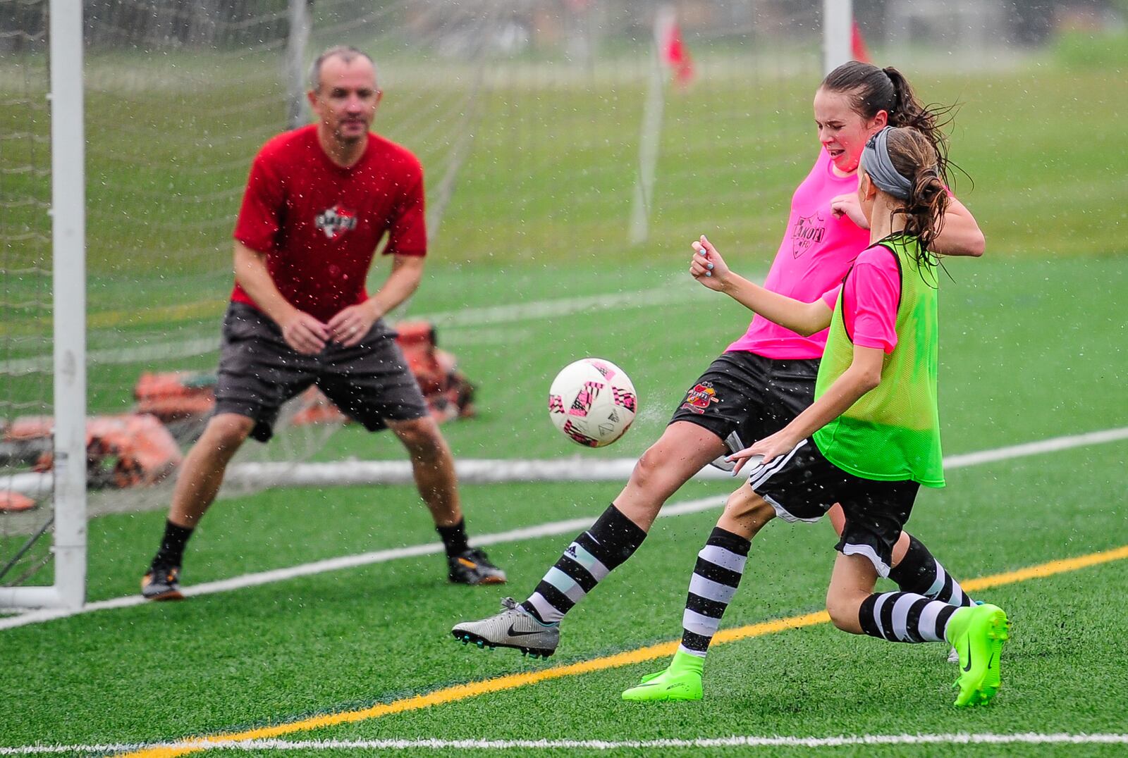 MetroParks of Butler County is planning to improve two more fields at its Athletic Complext at VOA MetroPark. The state has earmarked $350,000 for the $2.14 million project. Pictured are players from Lakota Futbol Club as they practice in the rain on one of the synthetic turf fields in June 2017. The state previously awarded the parks system $1 million for the Athletic Complex. NICK GRAHAM/STAFF