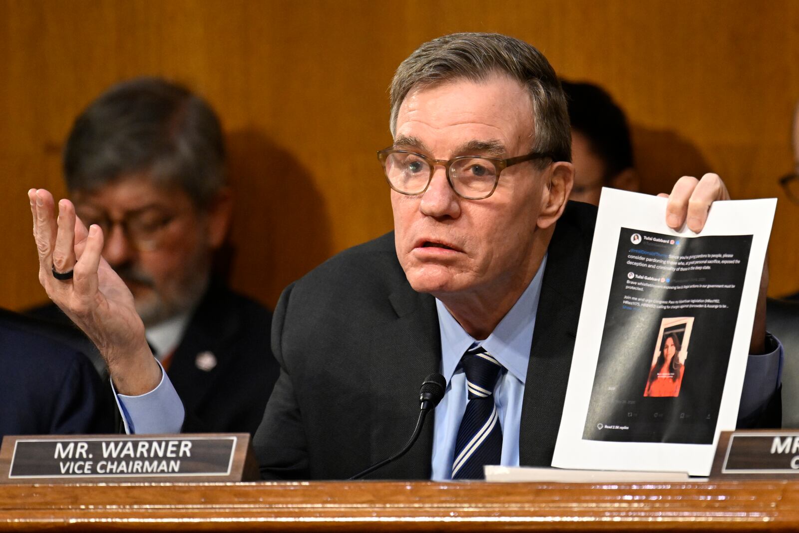 Vice Chairman Sen. Mark Warner, D-Va., questions Former Rep. Tulsi Gabbard, President Donald Trump's choice to be the Director of National Intelligence, on a social media post advocating the pardoning of Edward Snowden as she appears before the Senate Intelligence Committee for her confirmation hearing at the U.S. Capitol on Thursday, Jan. 30, 2025, in Washington. (AP Photo/John McDonnell)