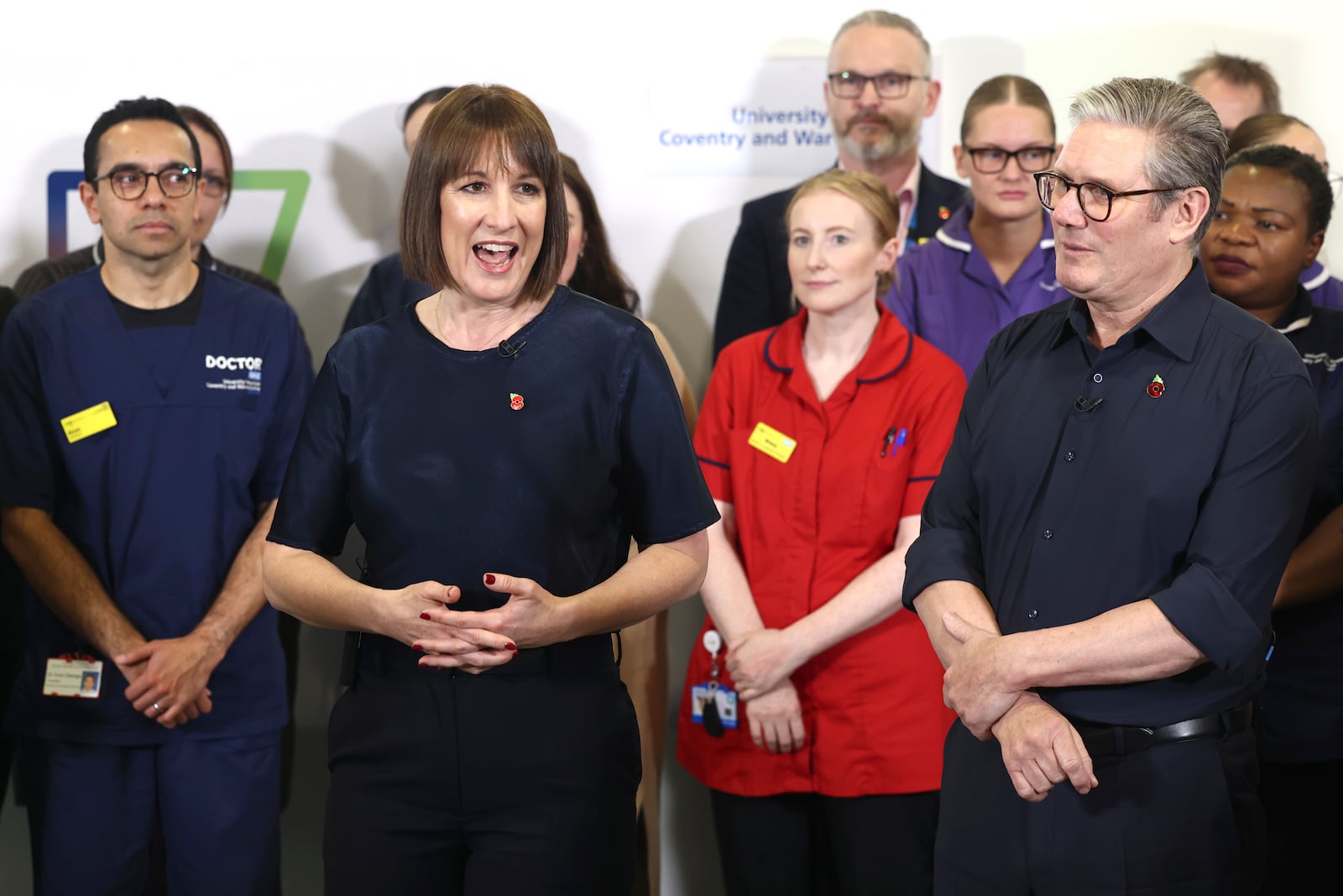 Britain's Prime Minister Keir Starmer and Chancellor Rachel Reeves speak with members of staff, during a visit to University Hospital Coventry and Warwickshire, in Coventry, England, Thursday, Oct. 31, 2024. (AP Photo/Darren Staples, pool)