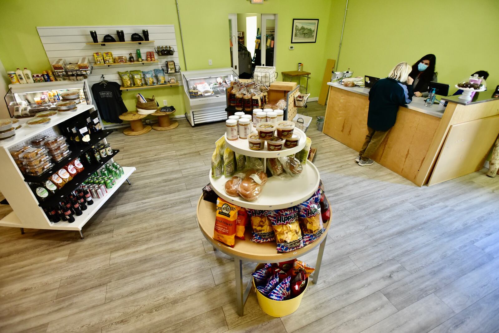 Ami Vitori works on some math skills with her 9-year-old son Marco Kimener as he helps calculate the correct change for customer Lynnette Schluter on opening day at Vitori's Market in Middletown Friday, May 1, 2020. The shop, which offers grocery store staples along with take-out items from Gracie's restaurant, is located inside the Torchlight Pass building at 1131 Central Ave. NICK GRAHAM/STAFF