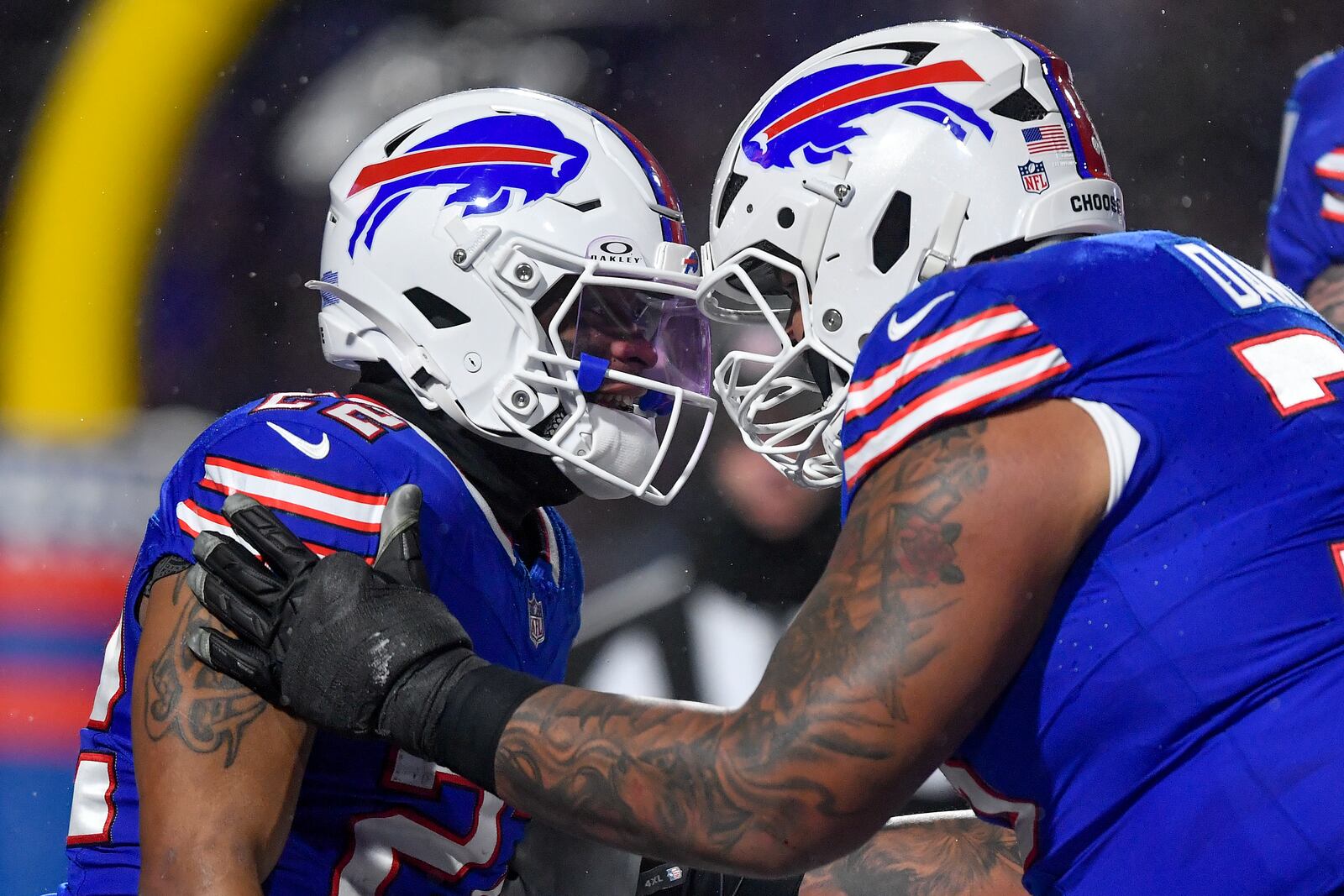 Buffalo Bills running back Ray Davis (22) celebrates with offensive tackle Dion Dawkins (73) after scoring a touchdown against the Baltimore Ravens during the first quarter of an NFL divisional playoff football game, Sunday, Jan. 19, 2025, in Orchard Park, N.Y. (AP Photo/Adrian Kraus)