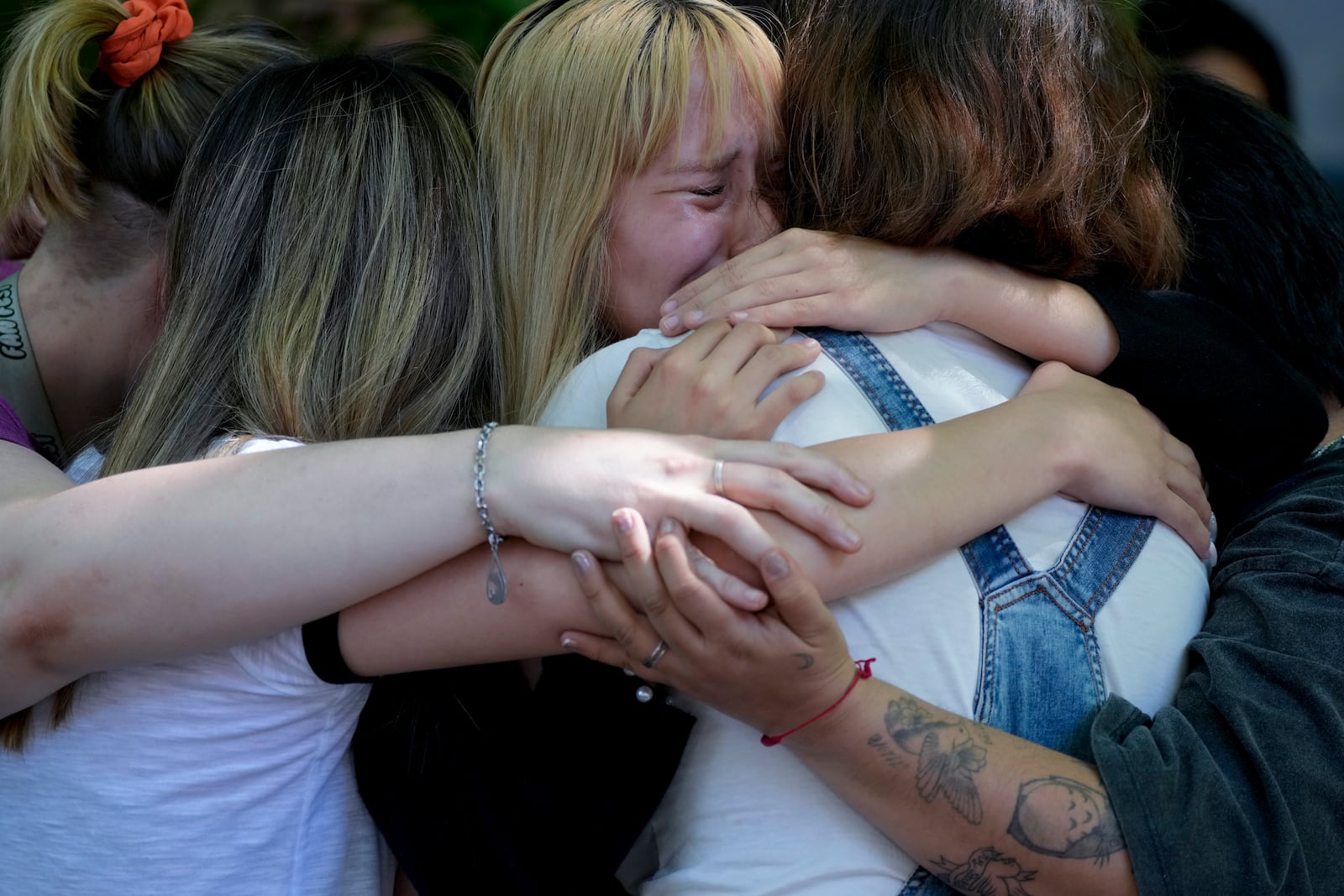 Fans of former One Direction singer Liam Payne grieve outside Casa Sur Hotel where the British pop singer fell to his death from a hotel balcony, in Buenos Aires, Argentina, Friday, Oct. 18, 2024. (AP Photo/Natacha Pisarenko)