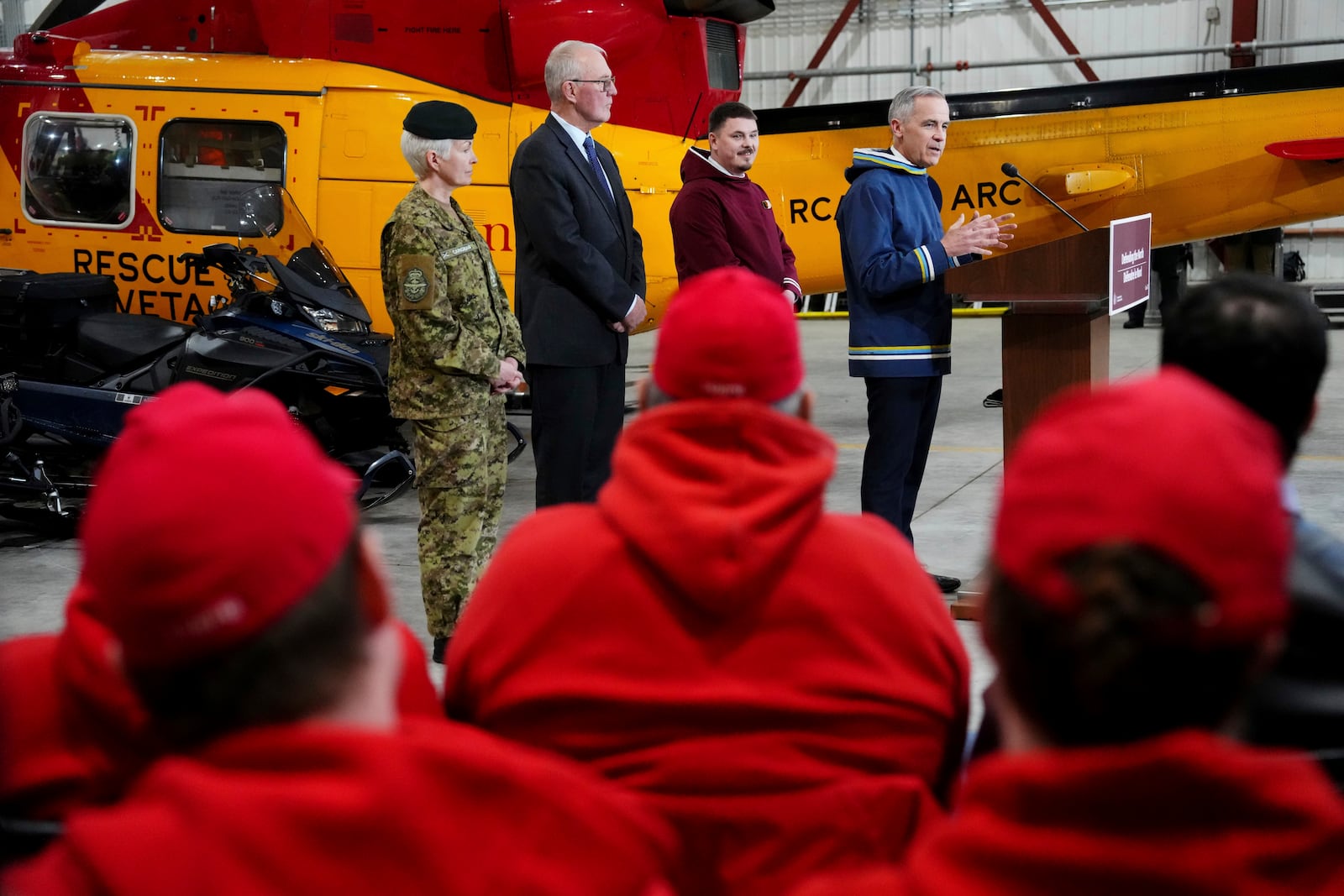 Canada Prime Minister Mark Carney, right to left, makes an announcement, as Nunavut Premier P.J. Akeeagok, Defence Minister Bill Blair and Chief of Defence Staff Gen. Jennie Carignan look on at a Canadian Armed Forces forward-operating location in Iqaluit, Nunavut, on Tuesday, March 18, 2025. (Sean Kilpatrick/The Canadian Press via AP)