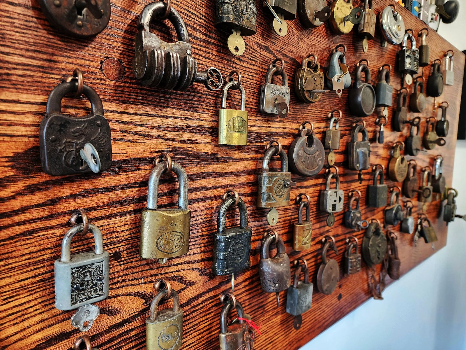 David Seidl, Miami University's vice president for information technology and chief information officer, has a unique hobby of picking locks and has a display board of  vintage locks behind his desk that his grandfather collected as a locksmith. NICK GRAHAM/STAFF