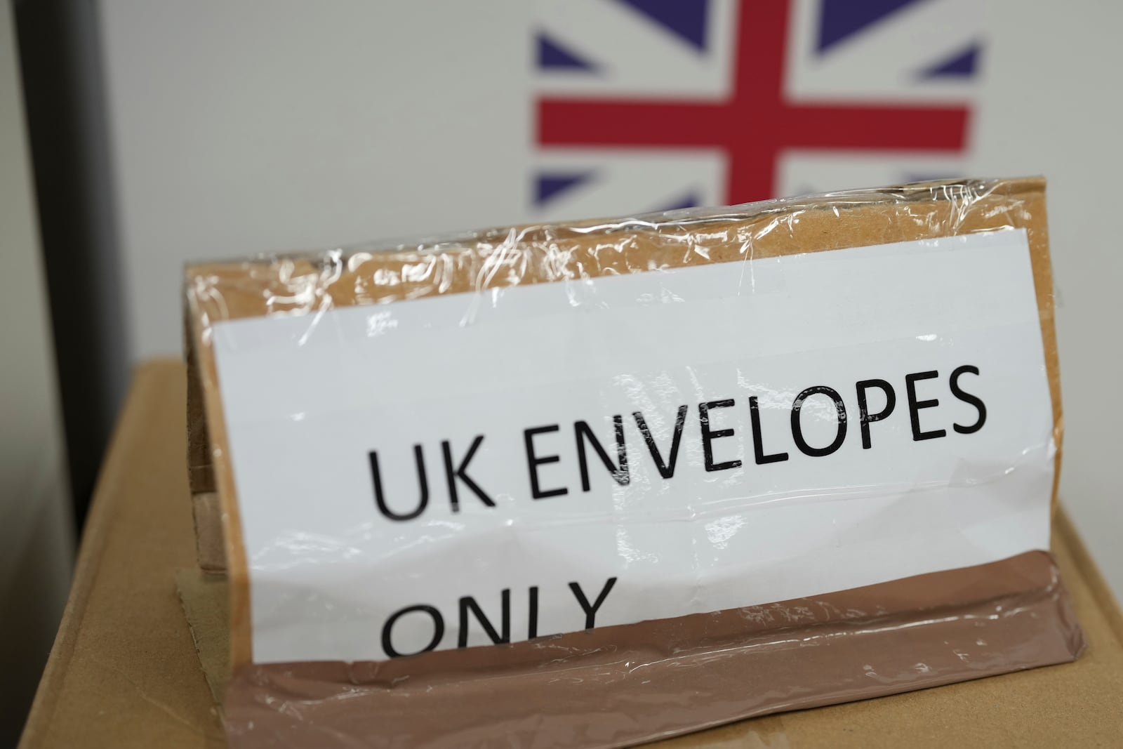 A sign for UK Envelopes only waits for packets of envelops containing labels at 'My Nametags' factory in London, Thursday, Jan. 30, 2025. (AP Photo/Alastair Grant)