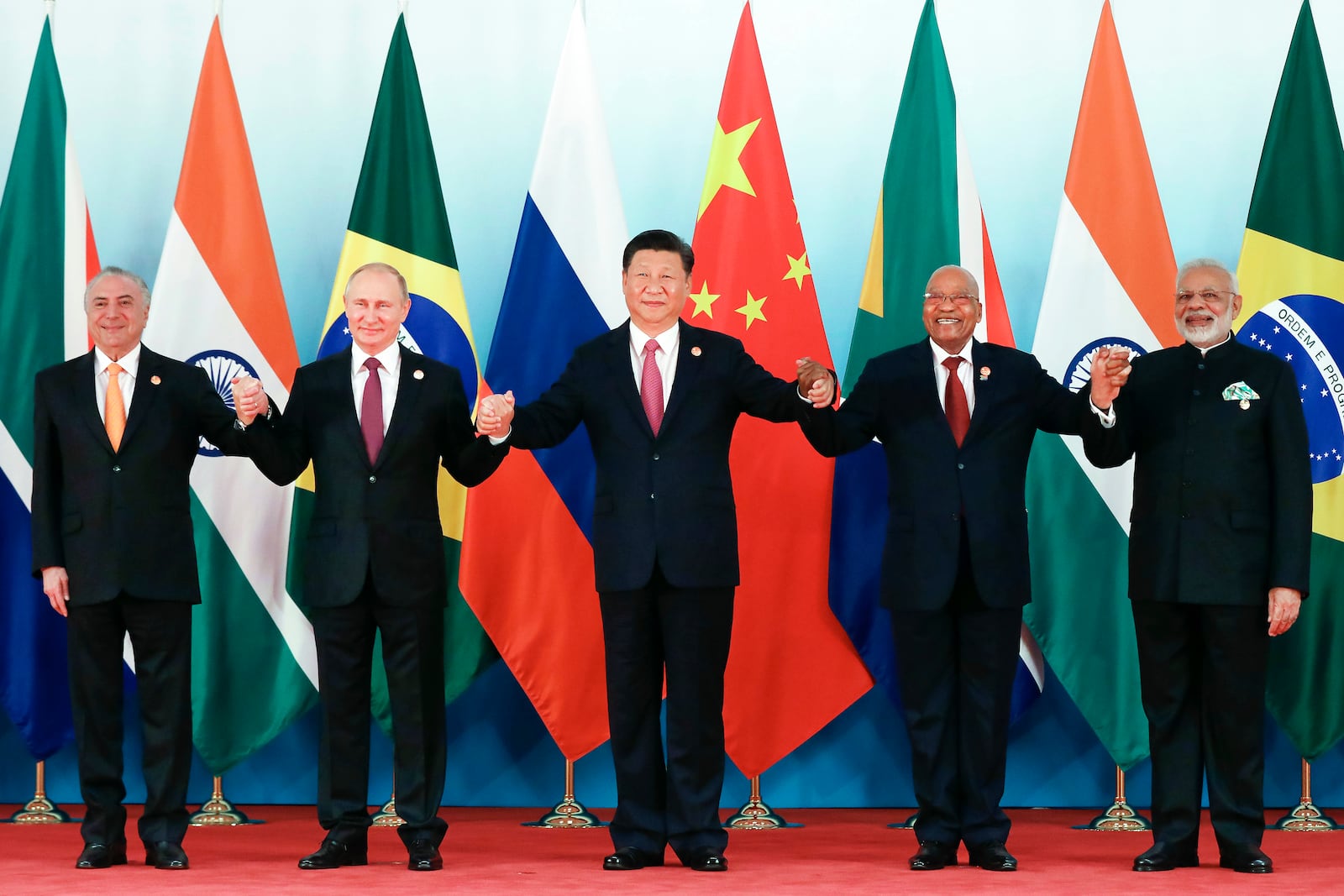 FILE - From left, Brazil's President Michel Temer, Russian President Vladimir Putin, Chinese President Xi Jinping, South Africa's President Jacob Zuma and Indian Prime Minister Narendra Modi pose for a group photo during the BRICS summit at the Xiamen International Conference and Exhibition Center in Xiamen, in southeastern China's Fujian province, on Sept. 4, 2017. (Wu Hong/Pool Photo via AP, File)