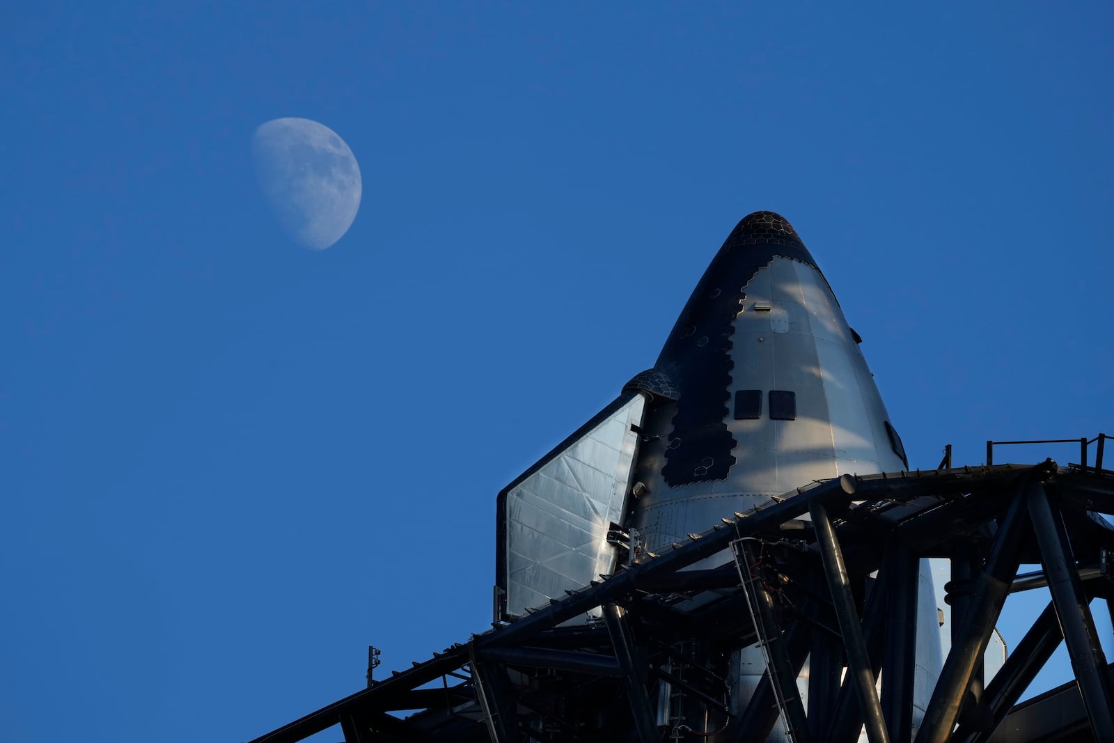 The moon rises over SpaceX's mega rocket Starship as it is prepares for a test launch Saturday, Oct. 12, 2024, in Boca Chica, Texas. (AP Photo/Eric Gay)