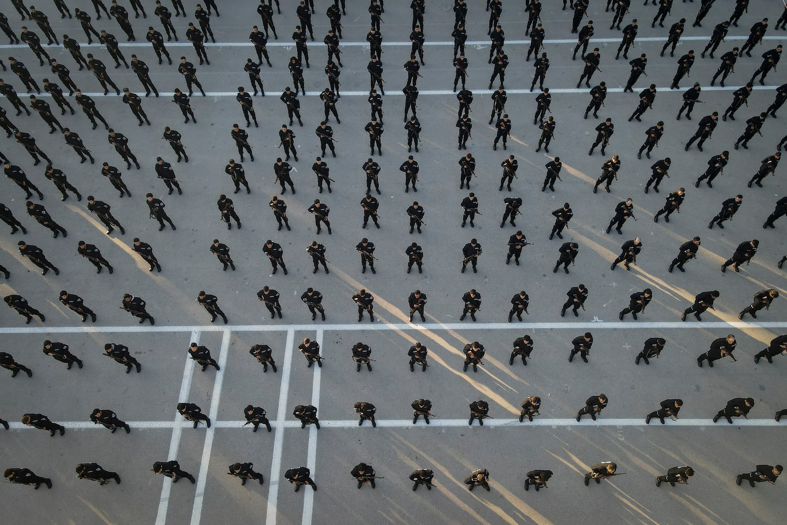 Recruits for the new government's police force stand in formation during a training and graduation session at the Police College in Damascus, Syria, Tuesday Jan. 14, 2025.(AP Photo/Omar Albam)