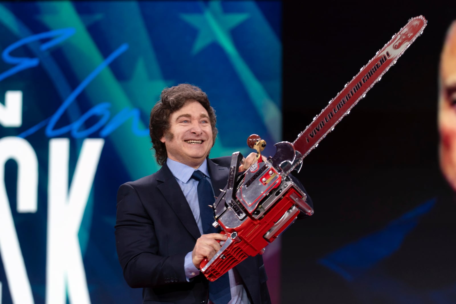 Argentina's President Javier Milei holds up a chainsaw as he arrives to speak at the Conservative Political Action Conference, CPAC, at the Gaylord National Resort & Convention Center, Thursday, Feb. 20, 2025, in Oxon Hill, Md. (AP Photo/Jose Luis Magana)