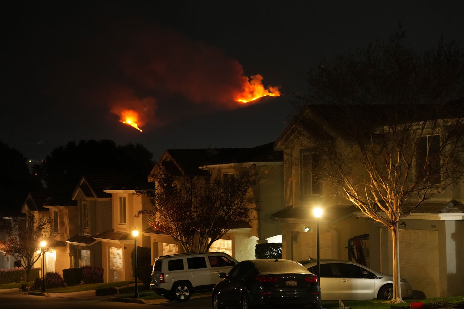 Homes in mandatory evacuation area in Castaic, Calf., are seen as the Hughes Fire burns afar Wednesday, Jan. 22, 2025. (AP Photo/Ethan Swope)