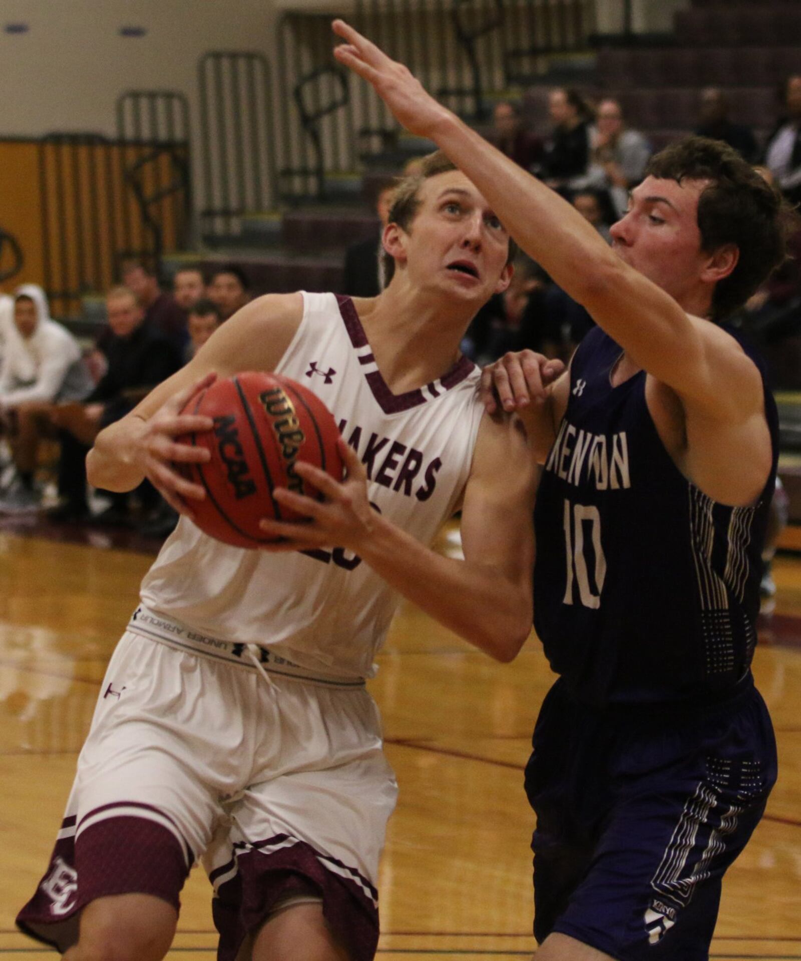 Earlham College’s Austin Doliboa (23) eyes the basket as Kenyon’s Bennett Grigull defends Nov. 15, 2017, at Richmond, Ind. Doliboa’s Quakers lost 95-81. PHOTO COURTESY OF EARLHAM ATHLETICS