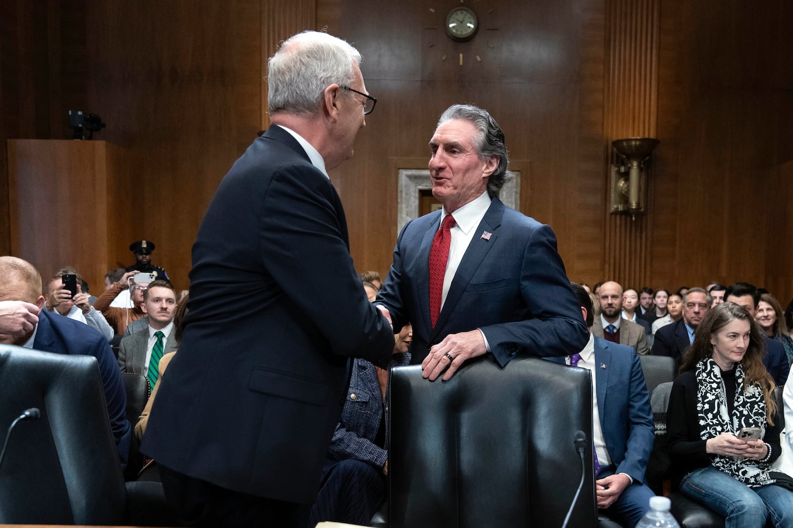 Sen. Kevin Cramer, R-N.D., left shake hands with former Gov. Doug Burgum, President-elect Donald Trump's choice to lead the the Interior Department as Secretary of the Interior, as he arrives to testify before the Senate Energy and Natural Resources Committee on Capitol Hill in Washington, Thursday, Jan. 16, 2025. (AP Photo/Jose Luis Magana)