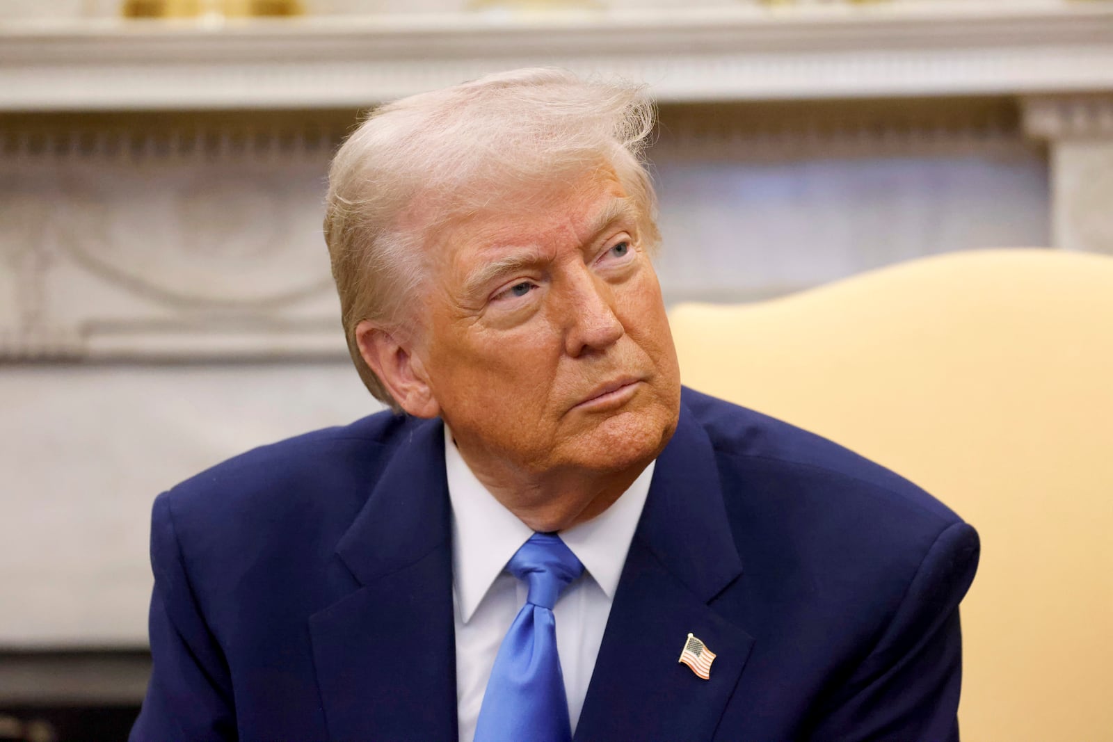 President Donald Trump listens during a meeting with France's President Emmanuel Macron in the Oval Office of the White House in Washington, Monday, Feb. 24, 2025. (Ludovic Marin/Pool via AP)