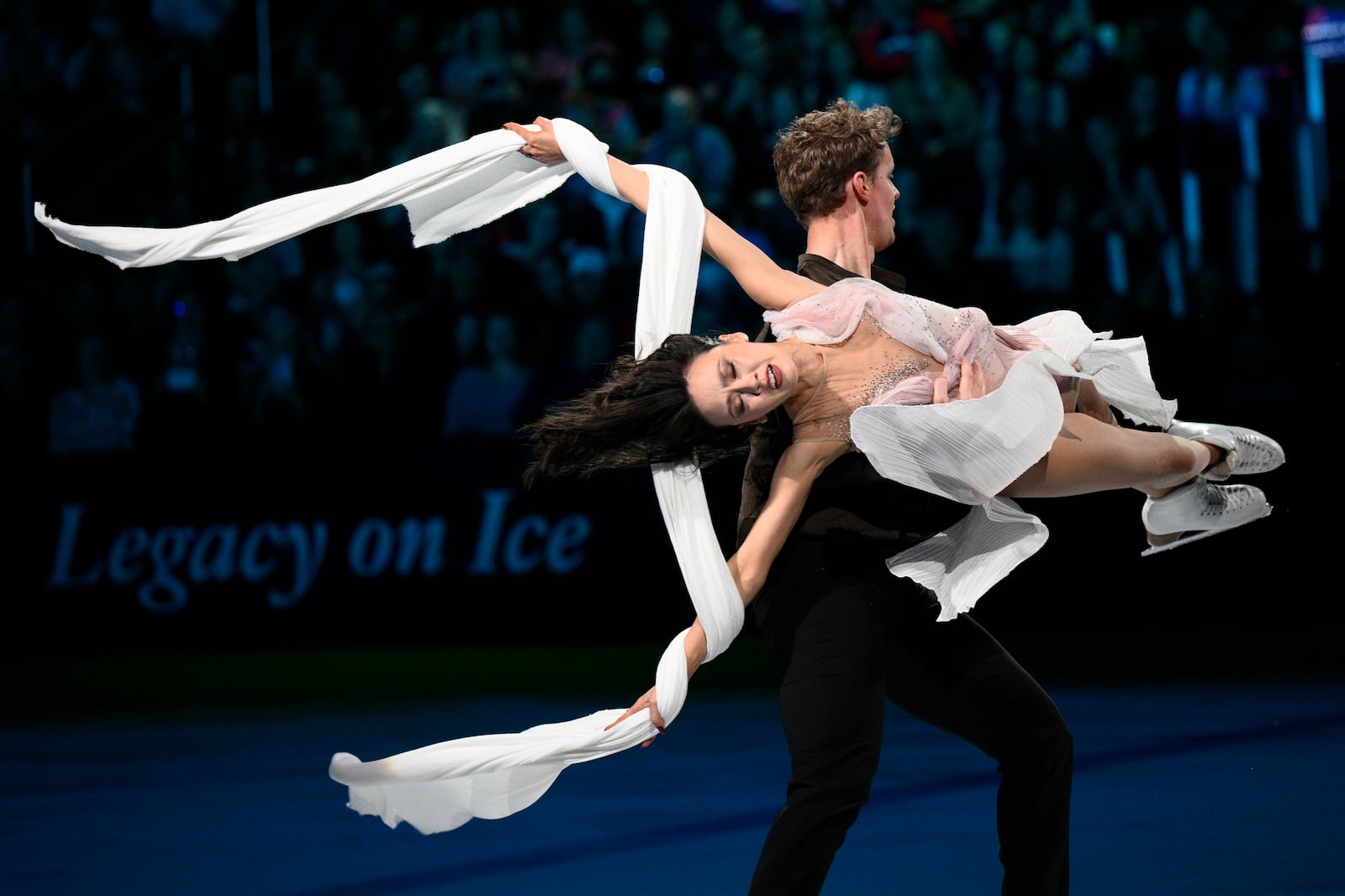 Madison Chock, front, and Evan Bates perform Sunday, March 2, 2025, in Washington, at the Legacy on Ice event, a figure skating tribute to support the families and loved ones affected by the Jan. 29 aviation incident. (AP Photo/Nick Wass)