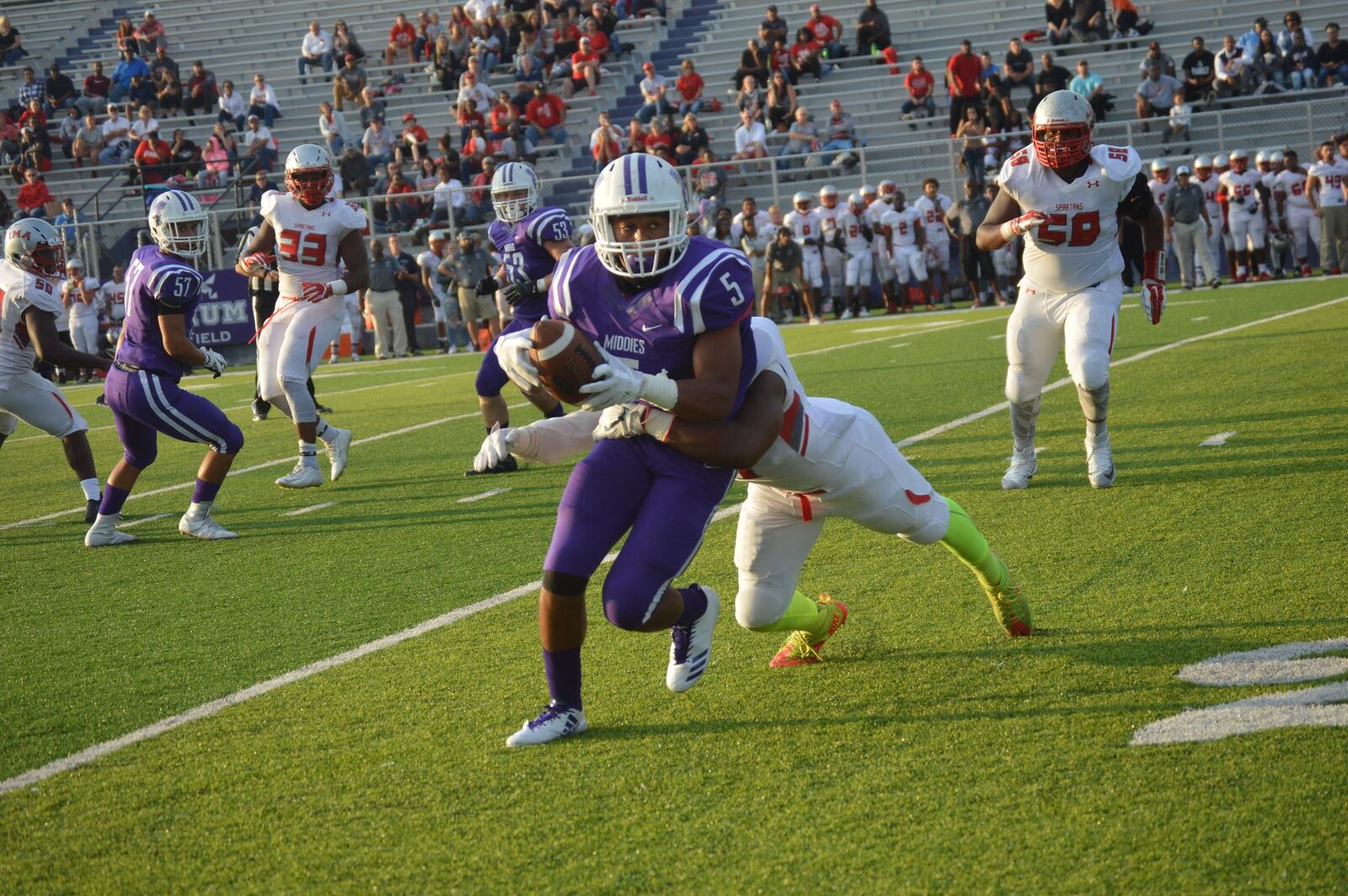 Middletown’s Diondre Cooper (5) tries to break free from a Lima Senior defender during last Friday’s game at Barnitz Stadium in Middletown. The host Middies dropped the season opener 34-14. CONTRIBUTED PHOTO BY MARITZA MCKINNEY