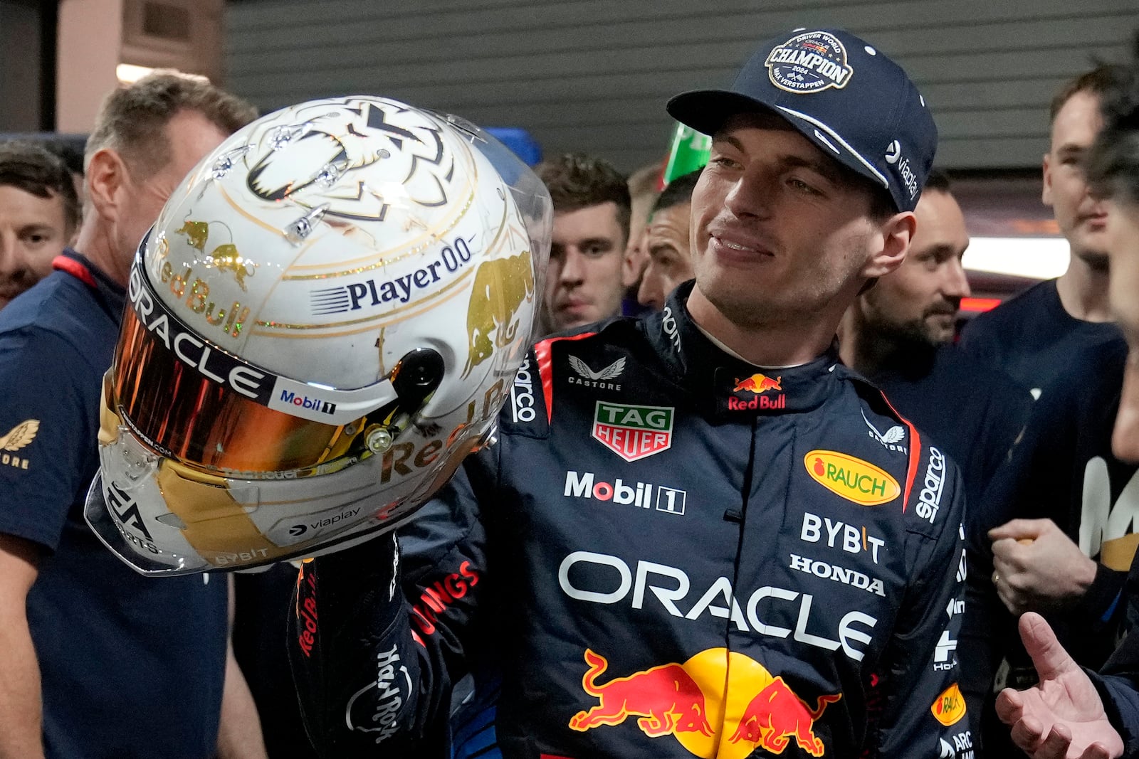 Red Bull driver Max Verstappen, of the Netherlands, looks at a helmet given to him by his team after winning the Formula 1 championship with his team after the F1 Las Vegas Grand Prix auto race, Sunday, Nov. 24, 2024, in Las Vegas. (AP Photo/Matt York)