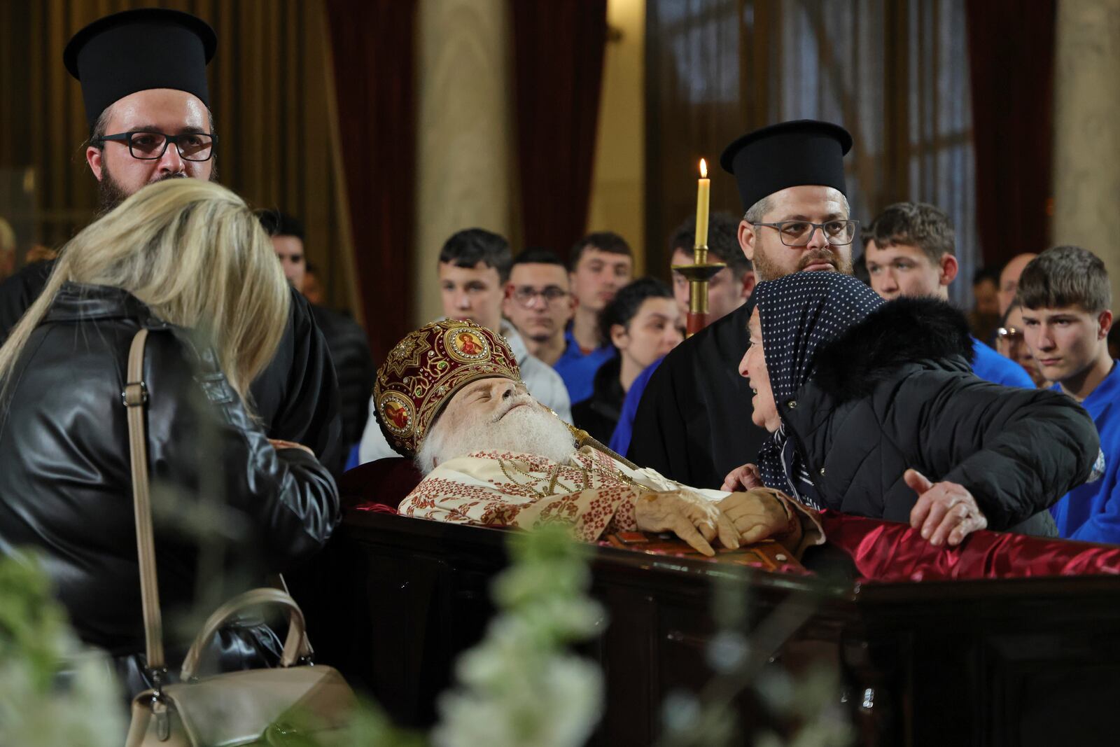 A woman pays her respects to the late Archbishop Anastasios of Tirana, Durres and All Albania during a religious ceremony, a day before his funeral, inside the Cathedral of the Resurrection of Christ, in Tirana, Albania, Wednesday, Jan. 29, 2025. (AP Photo/Vlasov Sulaj)