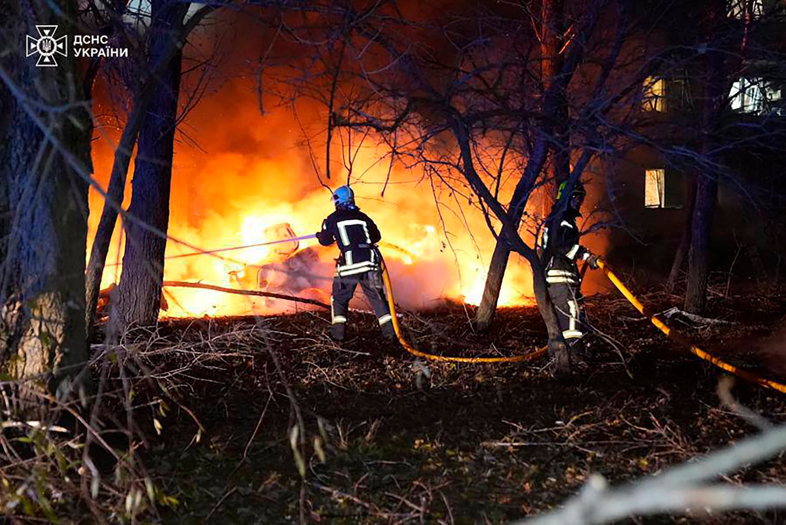 In this photo provided by the Ukrainian Emergency Service, firefighters extinguish the fire following a Russian rocket attack that hit a multi-storey apartment building in Sumy, Ukraine, Sunday, Nov. 17, 2024. (Ukrainian Emergency Service via AP)