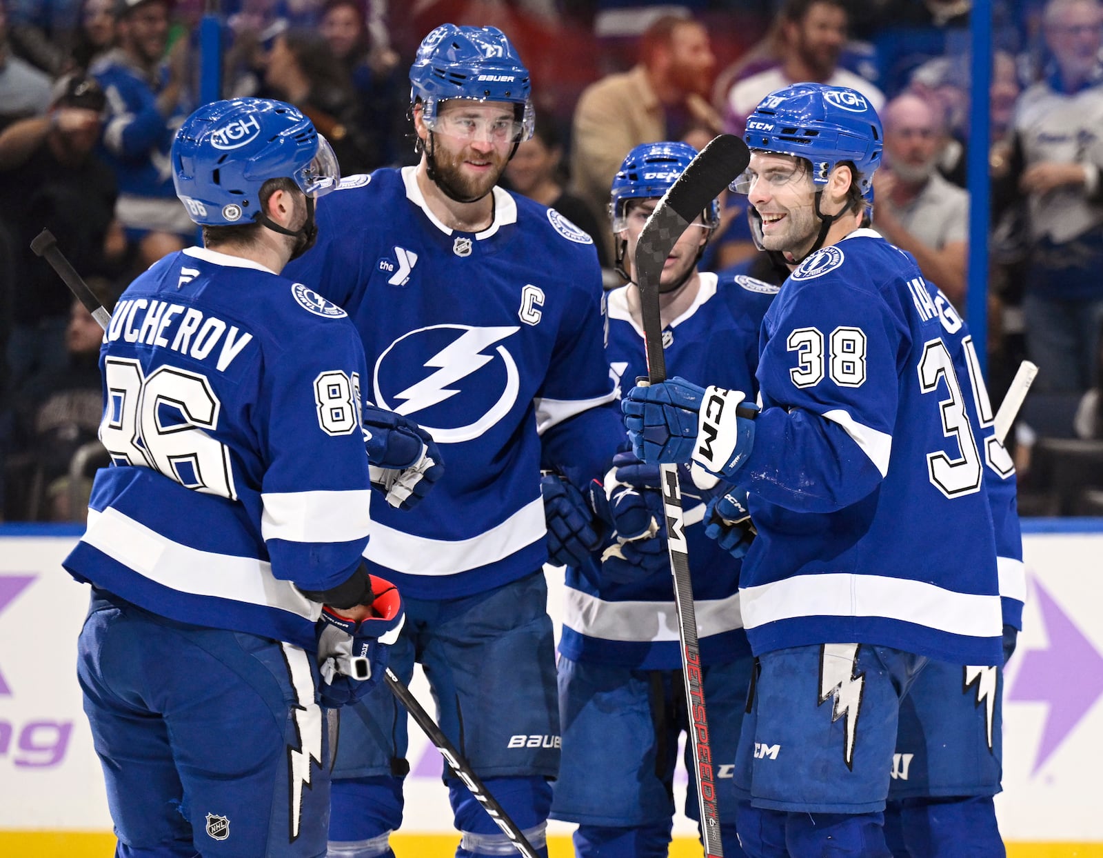 Tampa Bay Lightning right wing Nikita Kucherov (86), defenseman Victor Hedman (77), center Brayden Point (21), and left wing Brandon Hagel (38) celebrate after Point's goal during the second period of an NHL hockey game against the Colorado Avalanche, Monday, Nov. 25, 2024, in Tampa, Fla. (AP Photo/Jason Behnken)