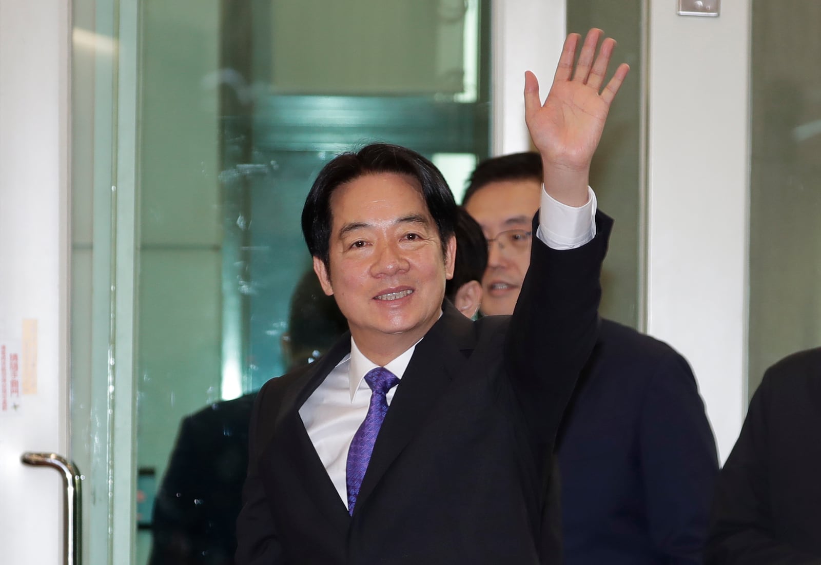 Taiwanese President Lai Ching-te waves to the media as he departs for South Pacific at Taoyuan International Airport in Taoyuan, Taiwan, Saturday, Nov. 30, 2024. Lai leave Taiwan on Saturday on a weeklong trip to visit the Marshall Islands, Tuvalu and Palau 'X three diplomatic allies of the self-governed island. (AP Photo/Chiang Ying-ying)