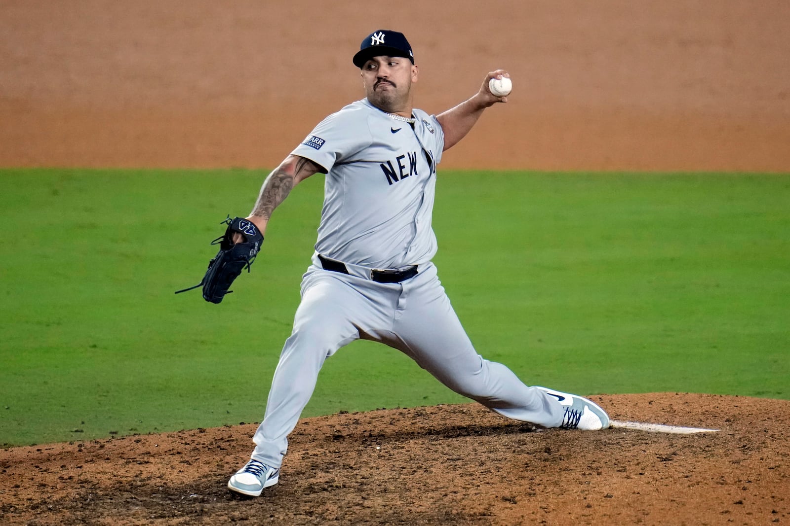 Los Angeles Dodgers pitcher Nestor Cortes throws against the Los Angeles Dodgers during the 10th inning in Game 1 of the baseball World Series, Friday, Oct. 25, 2024, in Los Angeles. (AP Photo/Julio Cortez)