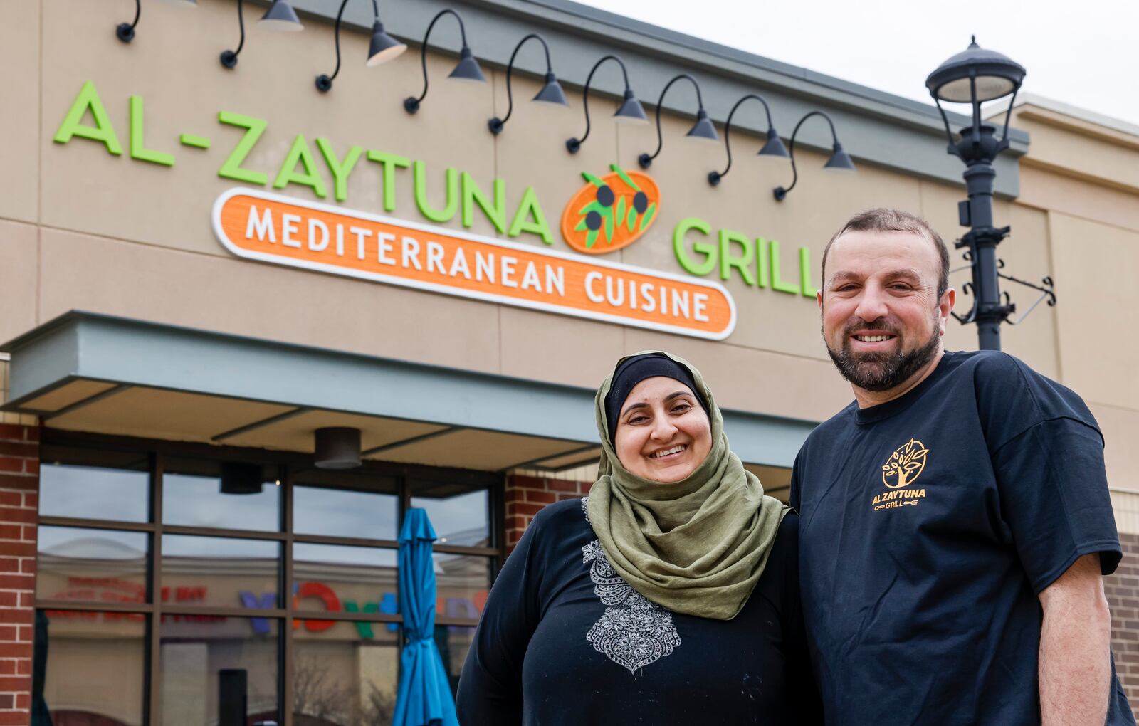 Maha Kayed, left, and Mohammad Jarabah have opened their Mediterranean cuisine restaurant, Al Zaytuna Grill, at Bridgewater Falls in Fairfield Township. NICK GRAHAM/STAFF