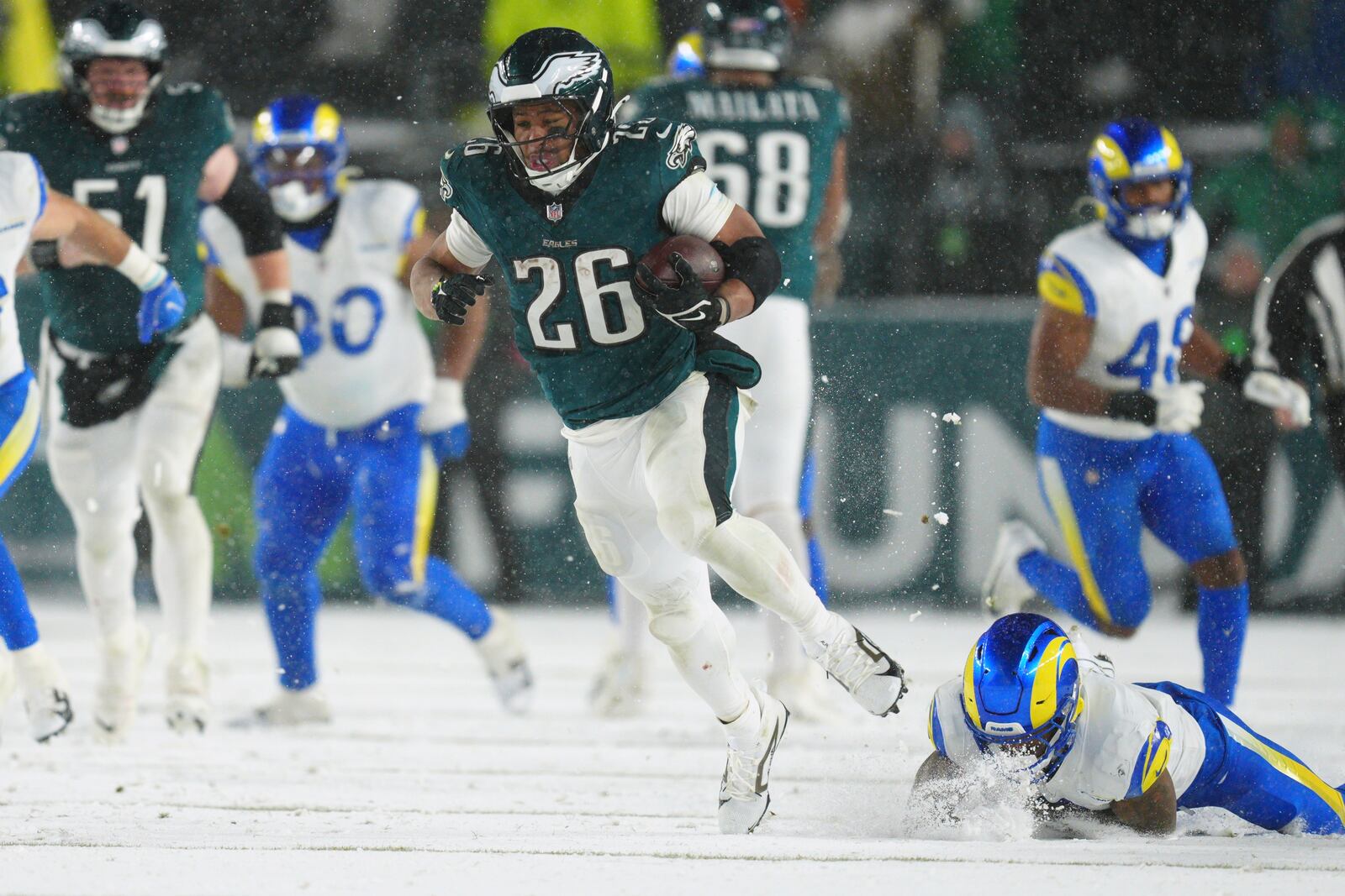 Philadelphia Eagles running back Saquon Barkley (26) runs the ball for a touchdown during the second half of an NFL football NFC divisional playoff game against the Los Angeles Rams on Sunday, Jan. 19, 2025, in Philadelphia. (AP Photo/Derik Hamilton)