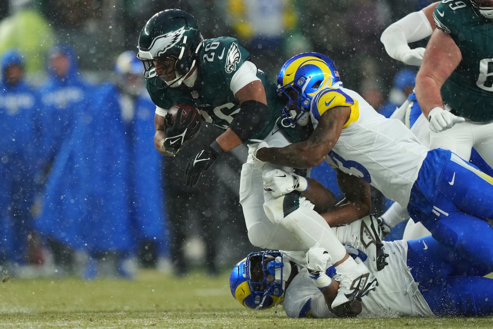 Philadelphia Eagles running back Saquon Barkley (26) is stopped by Los Angeles Rams safety Kamren Curl (3) during the first half of an NFL football NFC divisional playoff game Sunday, Jan. 19, 2025, in Philadelphia. (AP Photo/Matt Slocum)