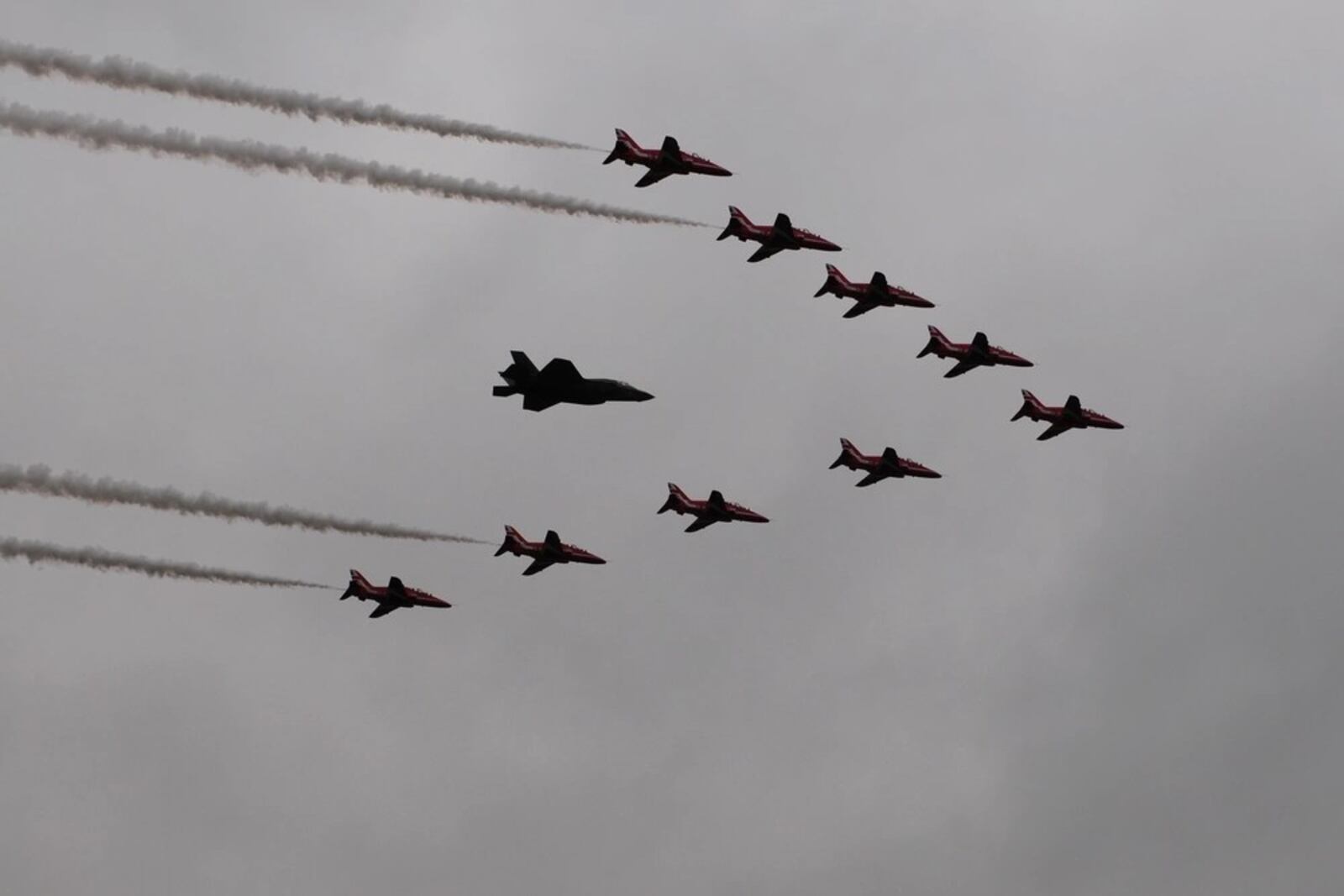 The Farnborough Air Show generated deals worth $50.8 billion across its first day, according to reports. In this 2016 photo, an F-35B Lighting II participates in a flyover with the Royal Air Force Aerobatic Team, the Red Arrows, during the first day of the Farnborough International Air Show that year. (U.S. Air Force photo by Master Sgt. Eric Burks/Released)