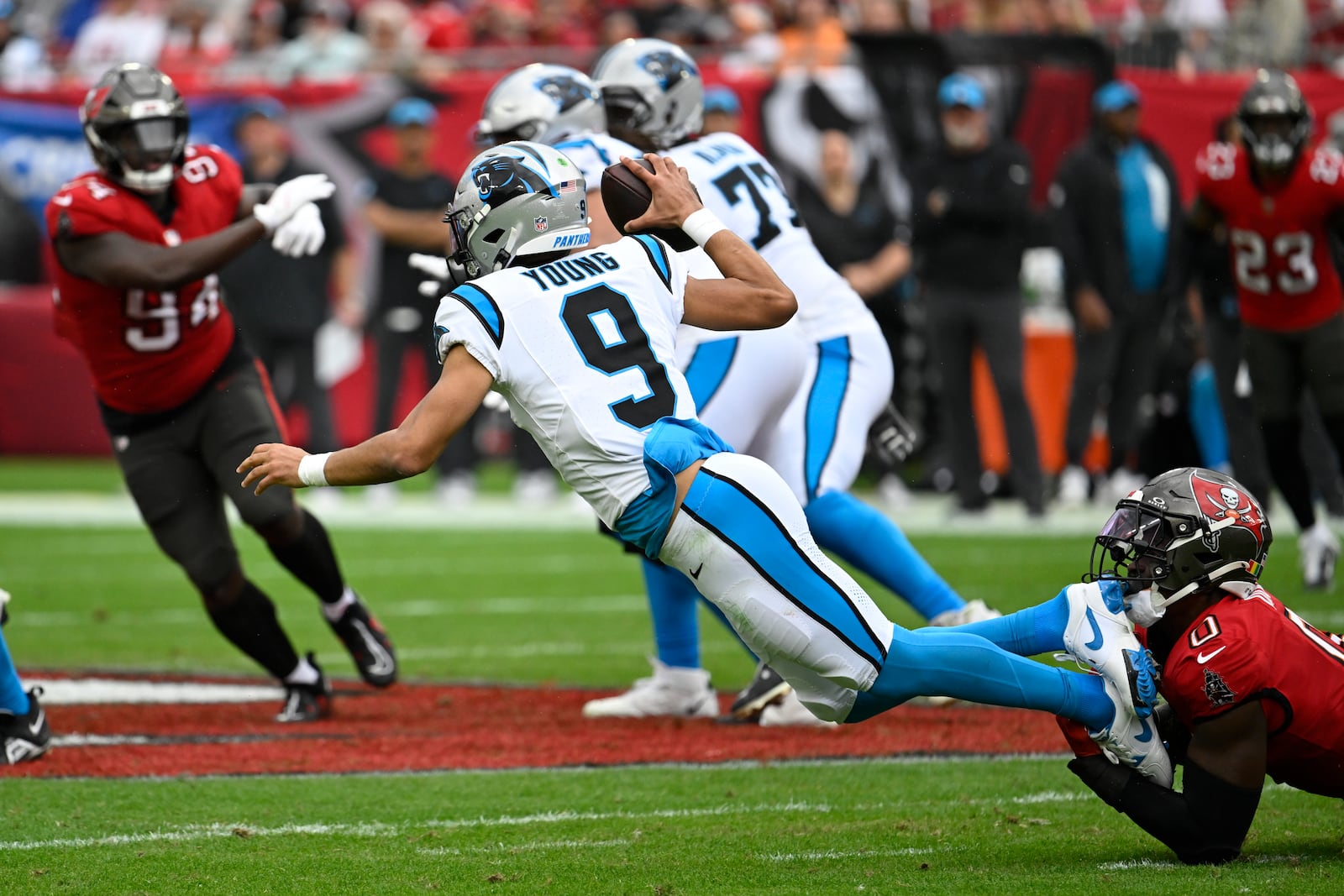 Carolina Panthers tight end Ja'Tavion Sanders is sacked by Tampa Bay Buccaneers linebacker Yaya Diaby during the second half of an NFL football game Sunday, Dec. 29, 2024, in Tampa, Fla. (AP Photo/Jason Behnken)